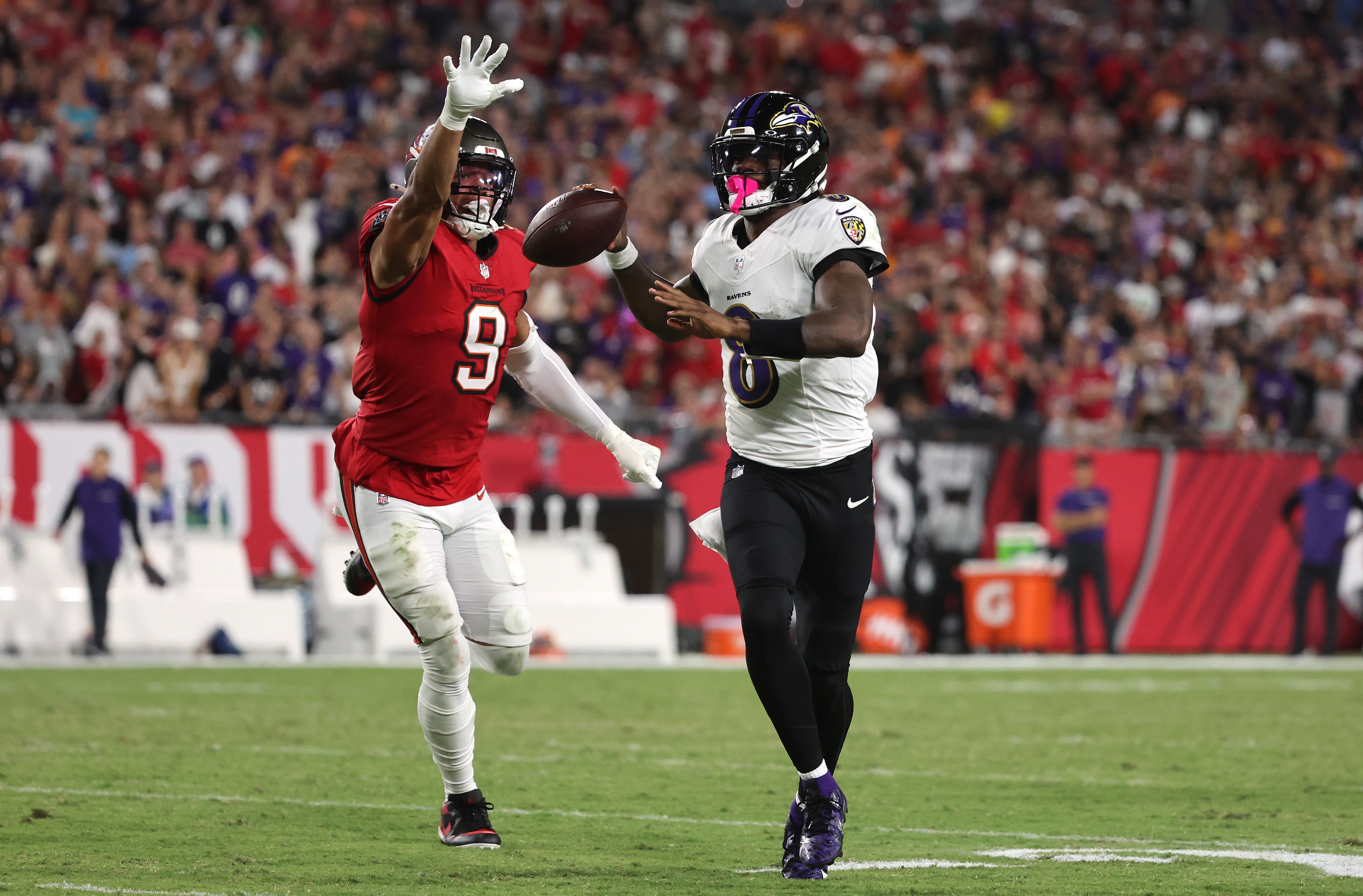 Oct 21, 2024; Tampa, Florida, USA; Baltimore Ravens quarterback Lamar Jackson (8) throws the ball as Tampa Bay Buccaneers linebacker Joe Tryon-Shoyinka (9) defends during the first half at Raymond James Stadium.