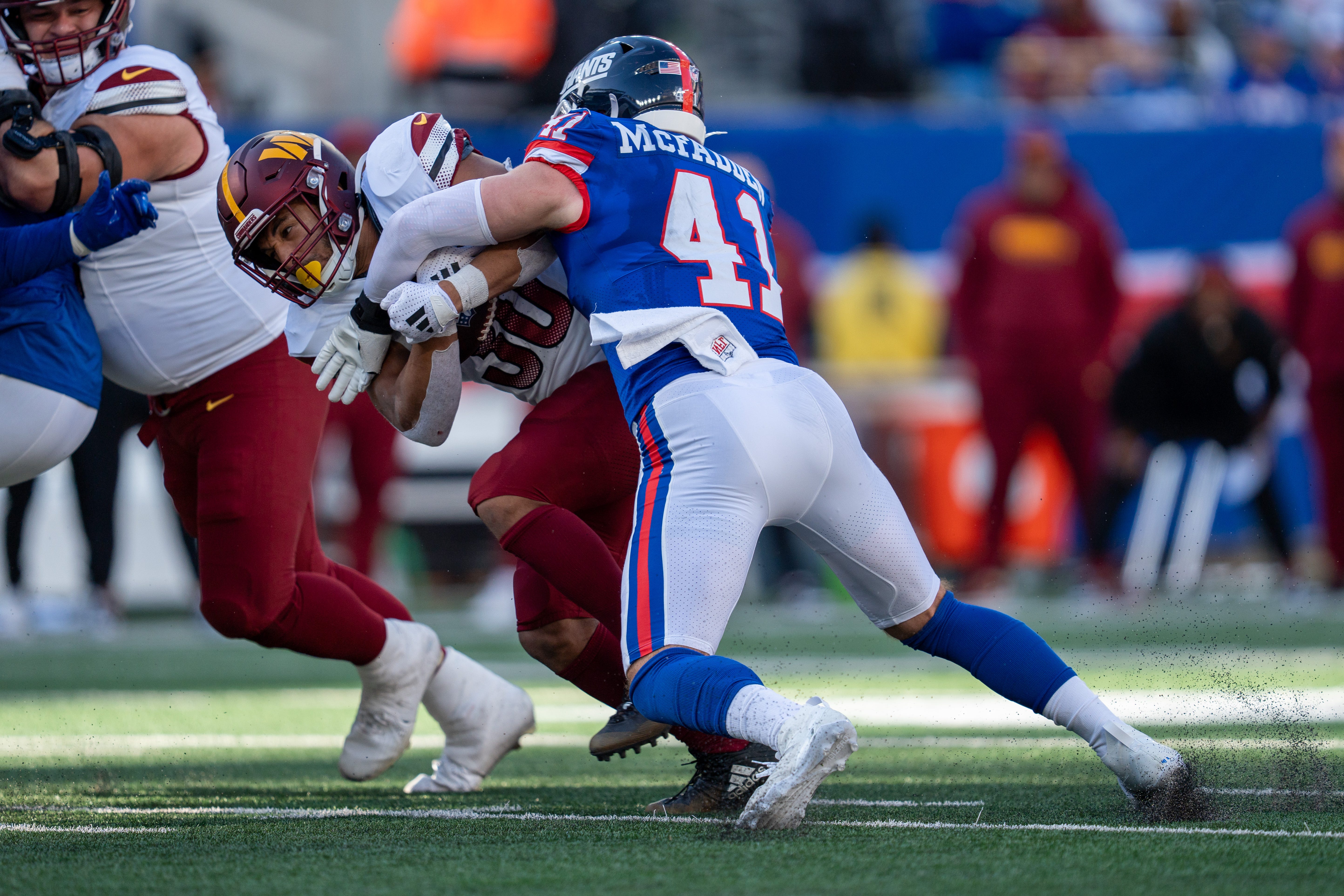 New York Giants linebacker Micah McFadden (41) makes a tackle on Washington Commanders running back Austin Ekeler (30) during a game between the New York Giants and the Washington Commanders at MetLife Stadium in East Rutherford on Sunday, Nov. 3, 2024.
