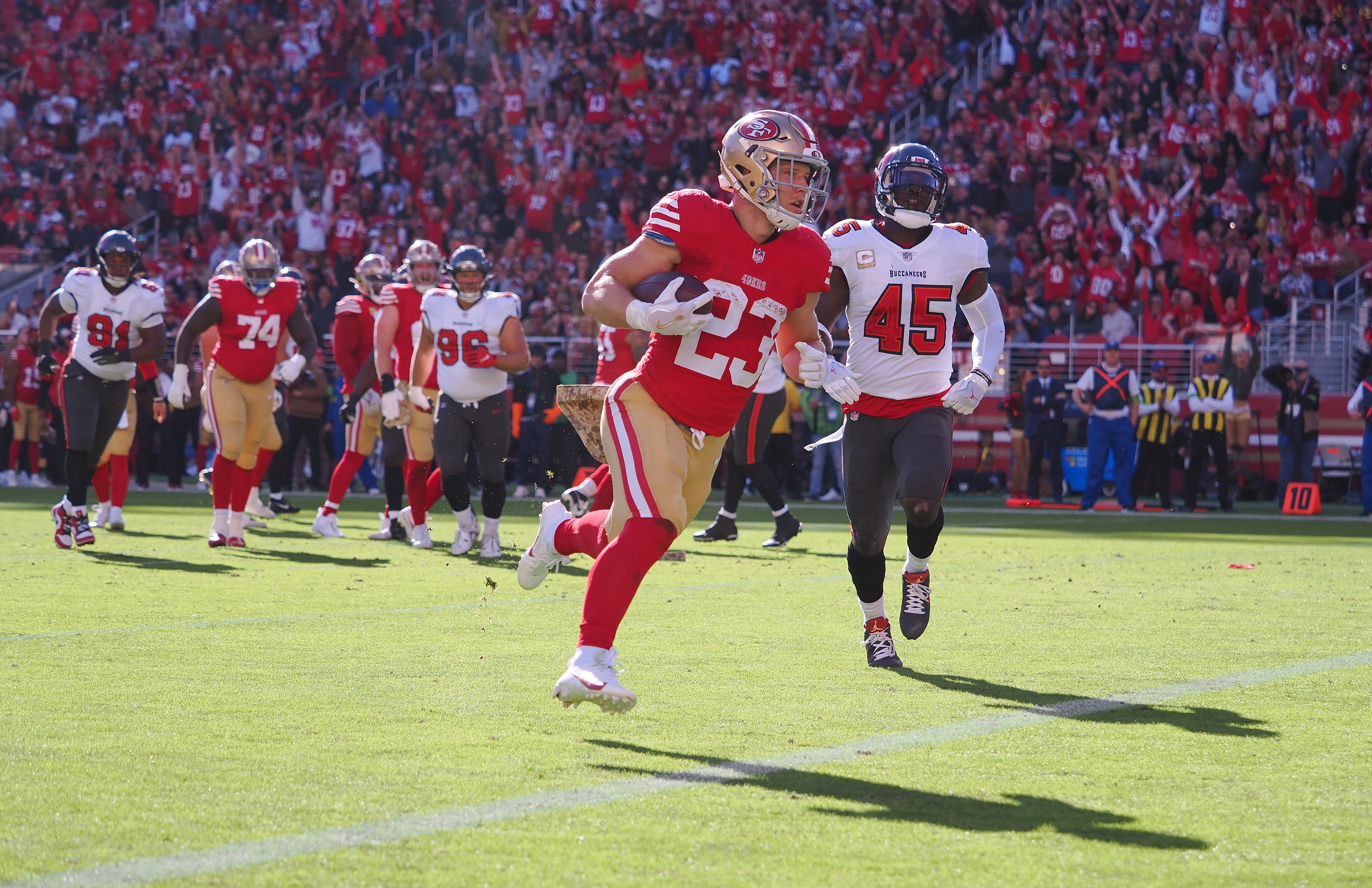 San Francisco 49ers running back Christian McCaffrey (23) scores a touchdown against the Tampa Bay Buccaneers during the first quarter at Levi's Stadium.