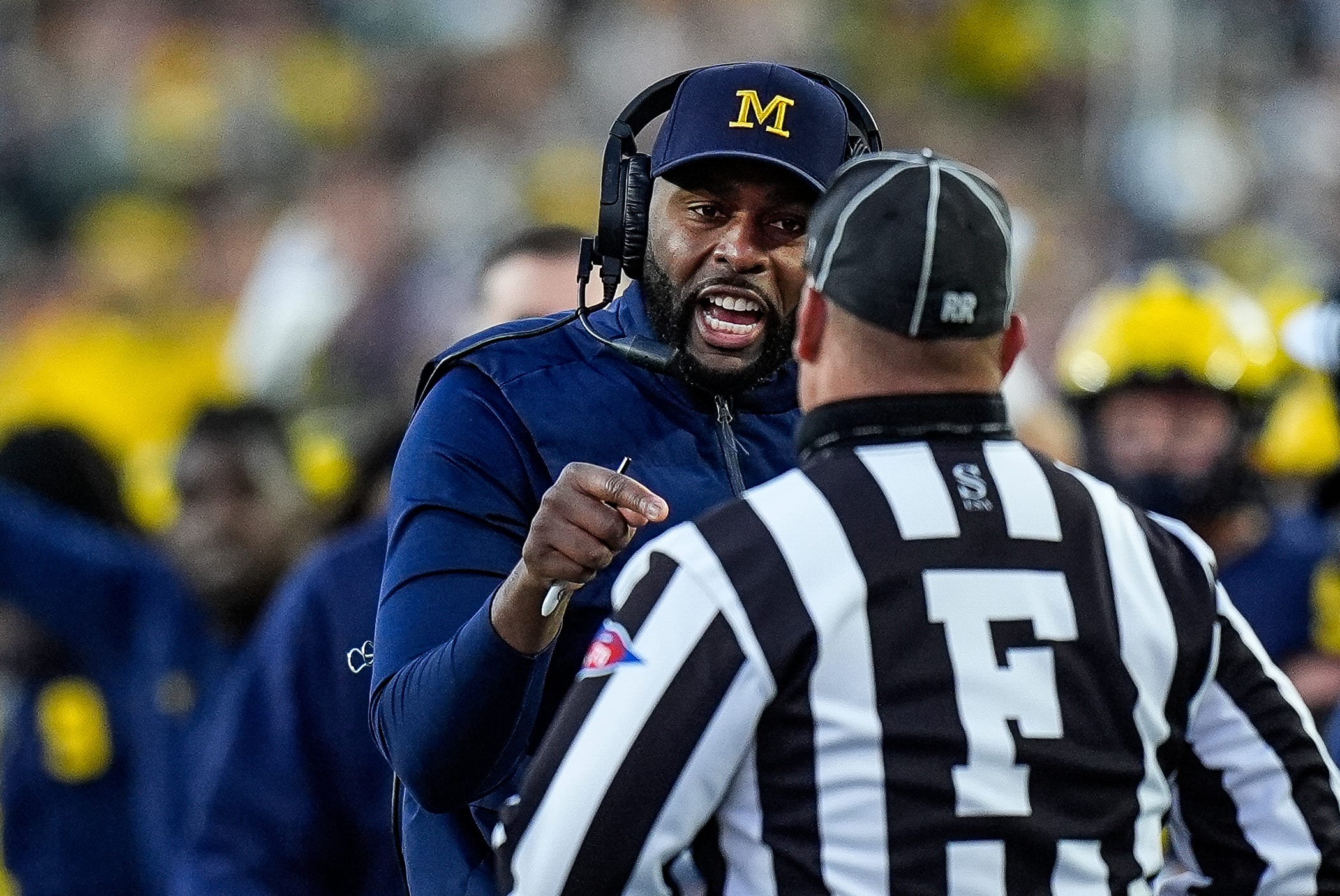 Michigan head coach Sherrone Moore talks to a referee and challenges an incomplete pass intended for tight end Colston Loveland (not in the photo) during the second half against Oregon at Michigan Stadium in Ann Arbor on Saturday, Nov. 2, 2024.