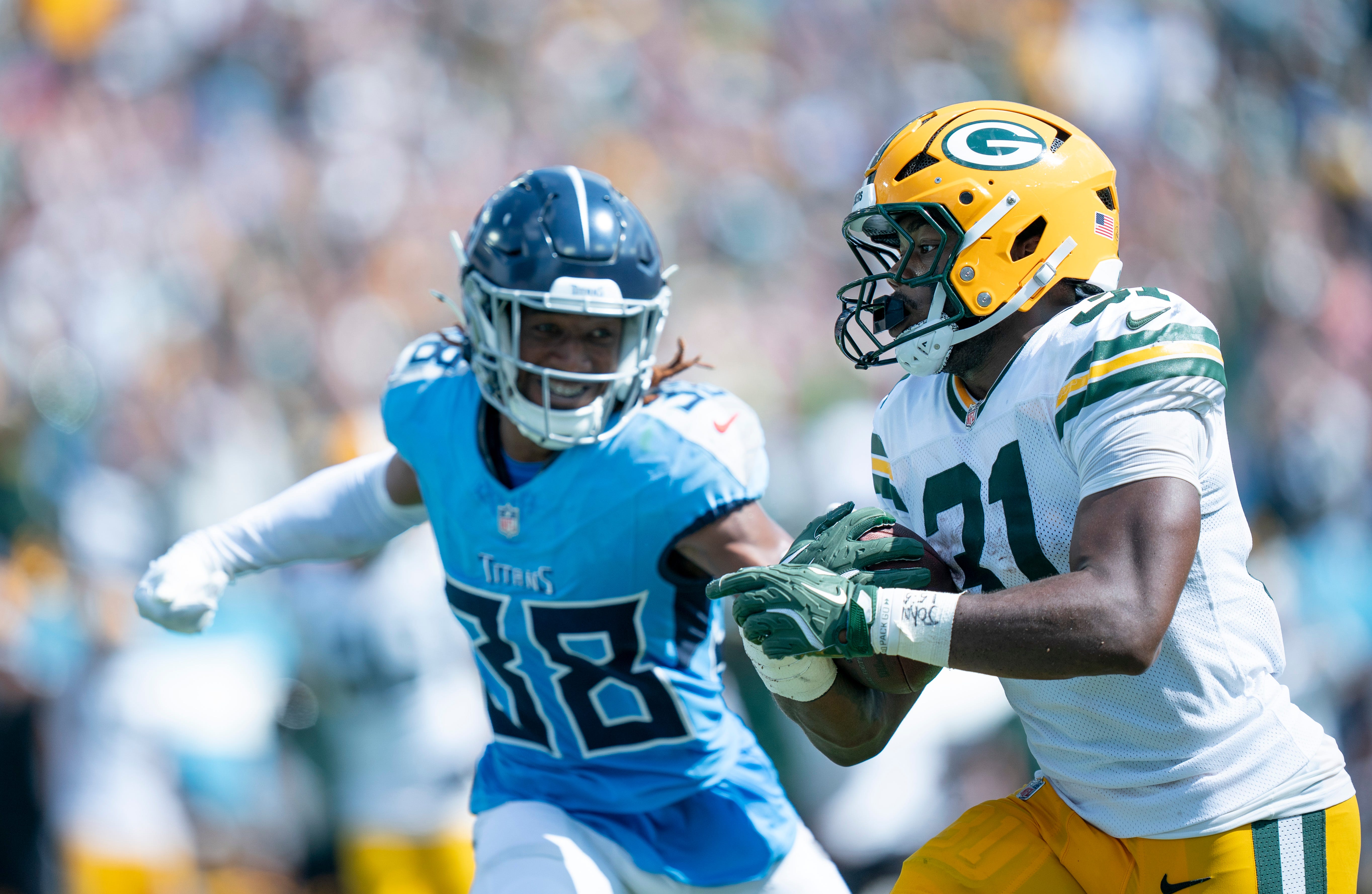 Green Bay Packers running back Emanuel Wilson (31) outruns Tennessee Titans cornerback L'Jarius Sneed (38) to score a 30 yard touchdown in the third quarter of their game at Nissan Stadium in Nashvill... Denny Simmons / The Tennessean-USA TODAY NETWORK via Imagn Images