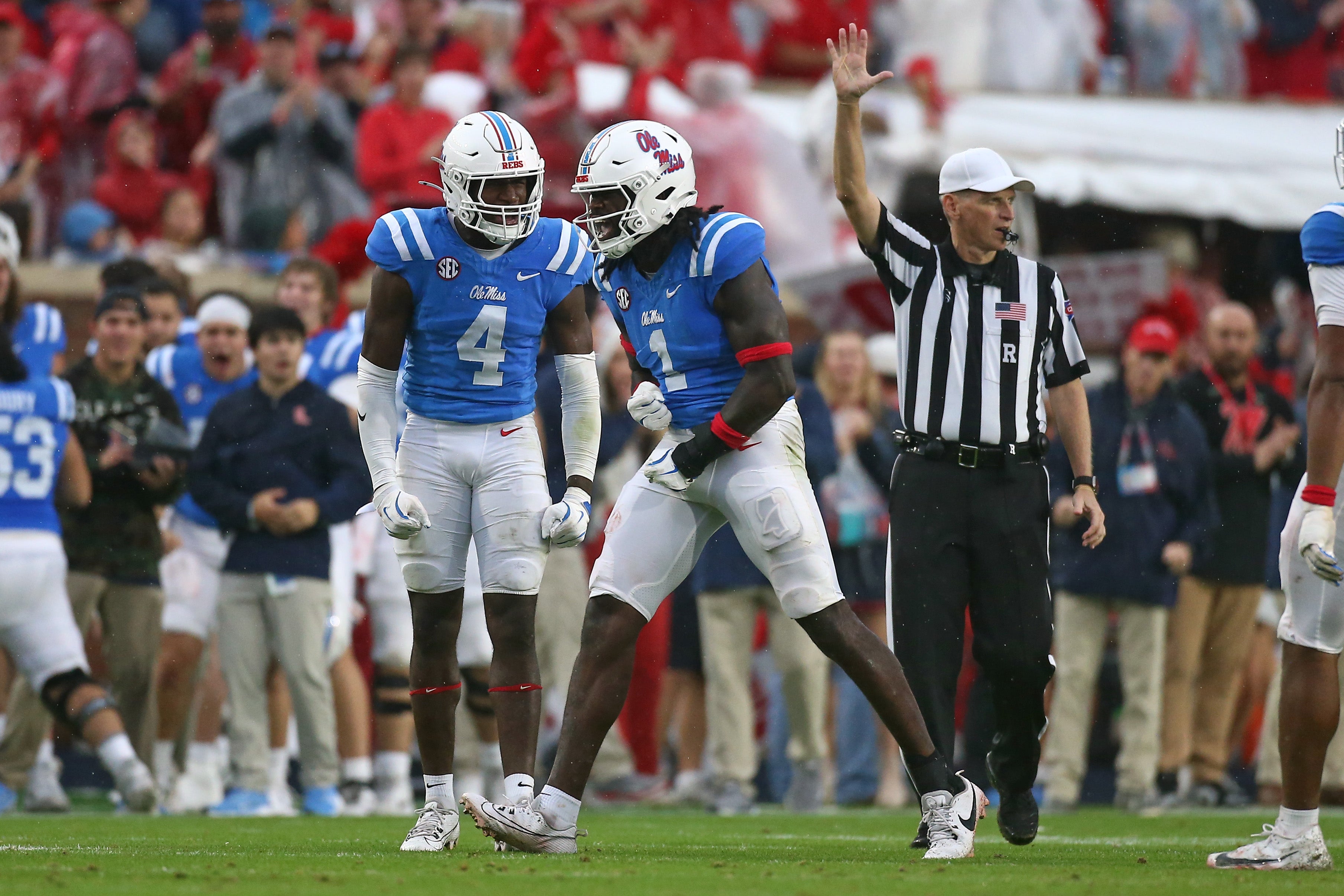 Nov 9, 2024; Oxford, Mississippi, USA; Mississippi Rebels linebacker Suntarine Perkins (4) reacts with defensive lineman Princely Umanmielen (1) after a defensive stop during the first half against the Georgia Bulldogs at Vaught-Hemingway Stadium.