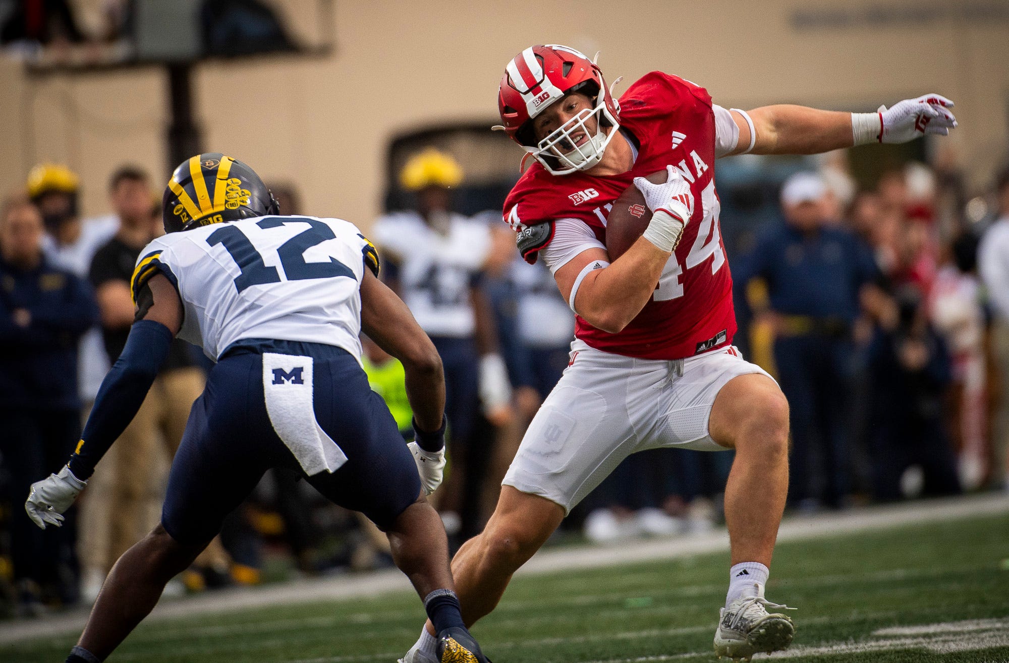 Indiana's Zach Horton (44) avoids Michigan's Aamir Hall (12) during the Indiana versus Michigan football game at Memorial Stadium on Friday, Nov. 9, 2024.