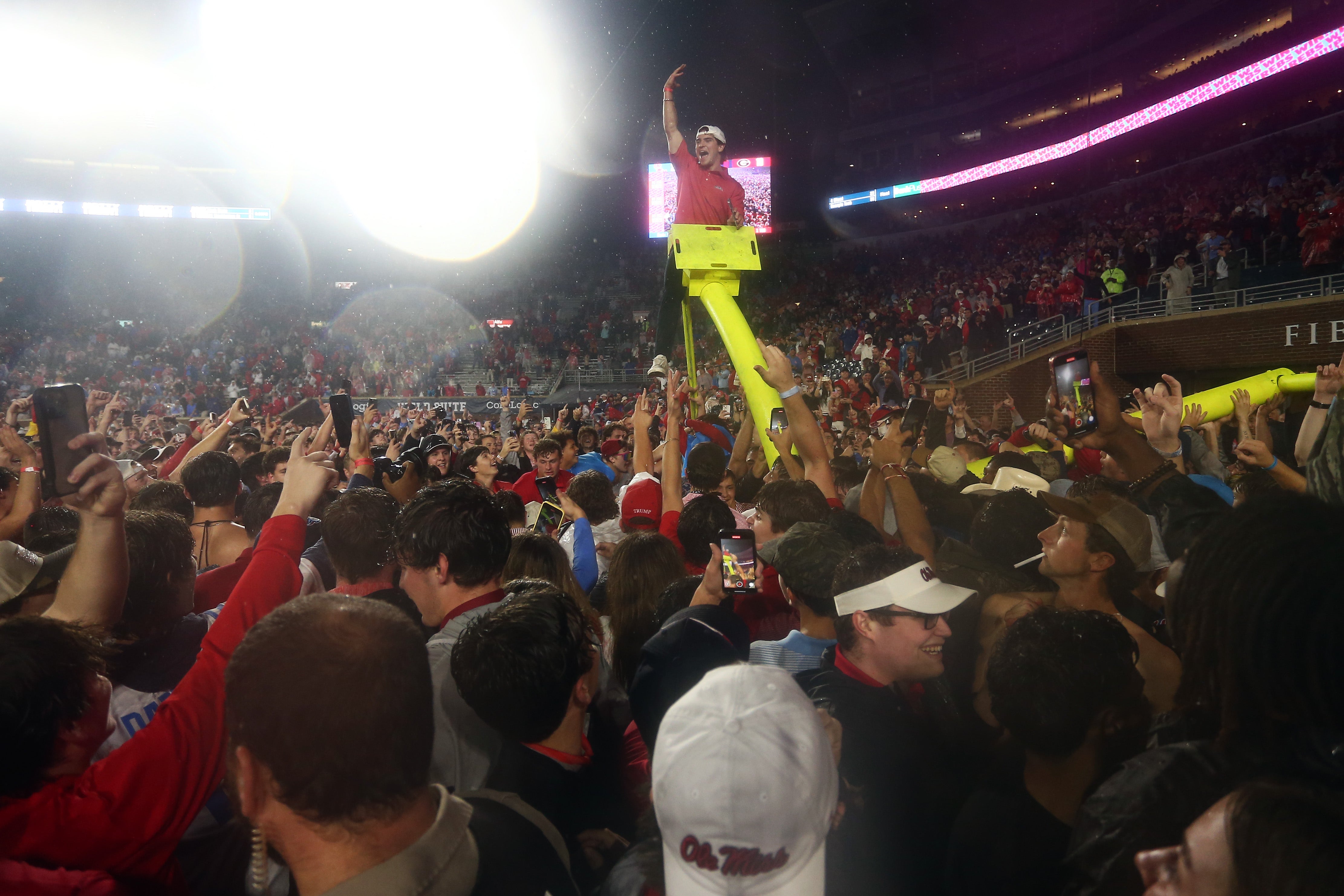 Nov 9, 2024; Oxford, Mississippi, USA; Mississippi Rebels fans react after tearing down the goal post after defeating the Georgia Bulldogs at Vaught-Hemingway Stadium.