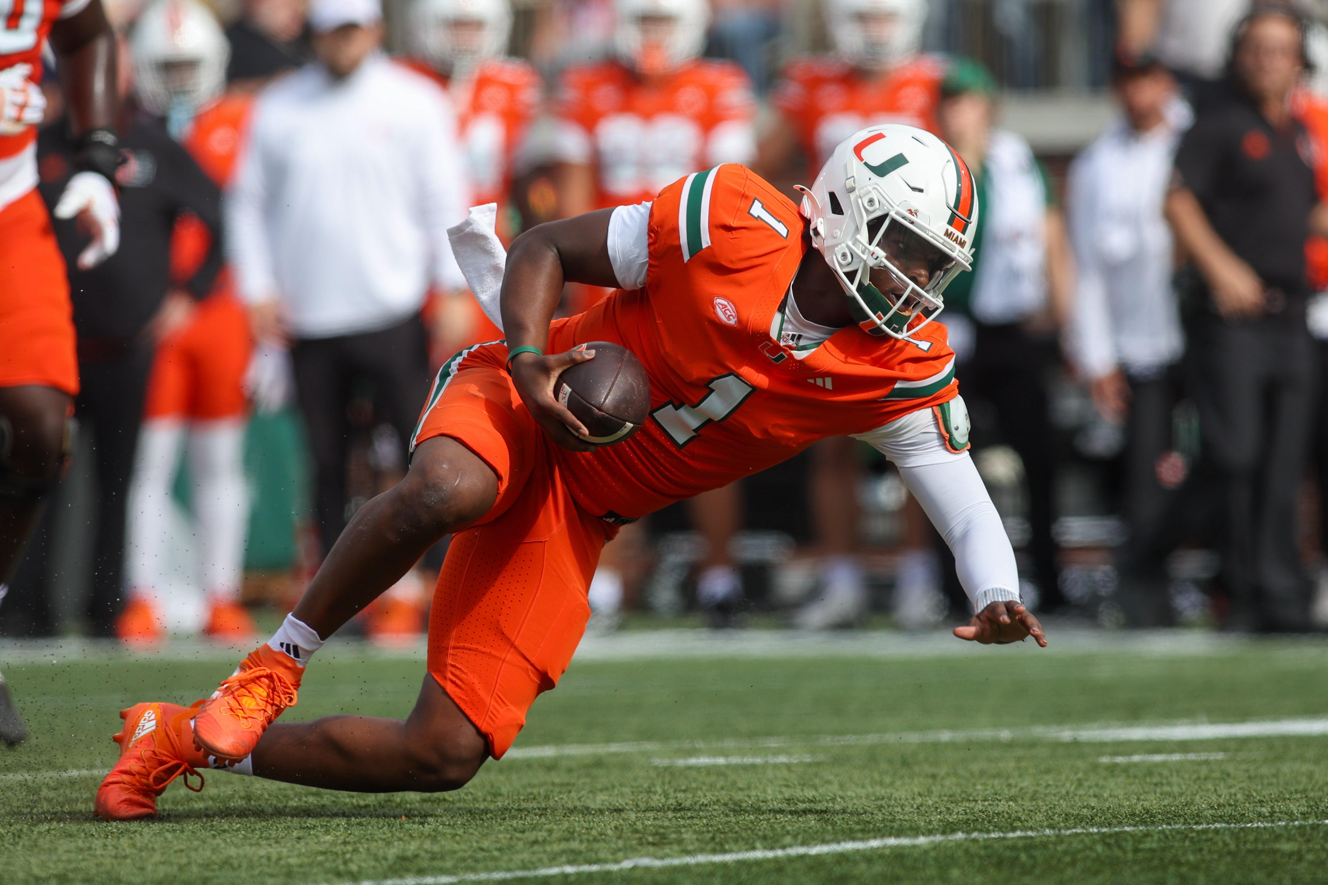 Nov 9, 2024; Atlanta, Georgia, USA; Miami Hurricanes quarterback Cam Ward (1) scrambles against the Georgia Tech Yellow Jackets in the second quarter at Bobby Dodd Stadium at Hyundai Field.