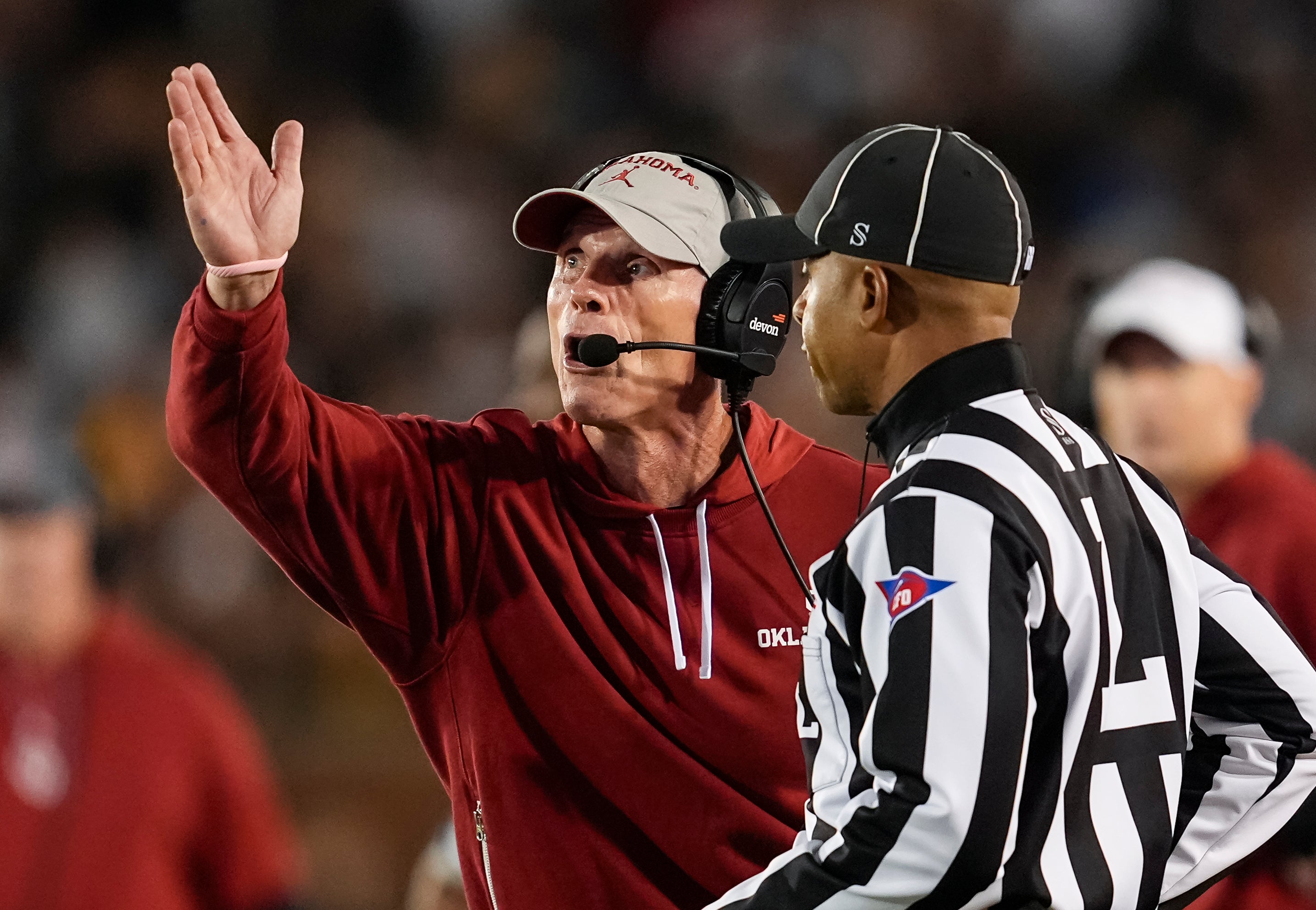 Nov 9, 2024; Columbia, Missouri, USA; Oklahoma Sooners head coach Brent Venables talks with line judge Jeremiah Harris during the first half against the Missouri Tigers at Faurot Field at Memorial Stadium.