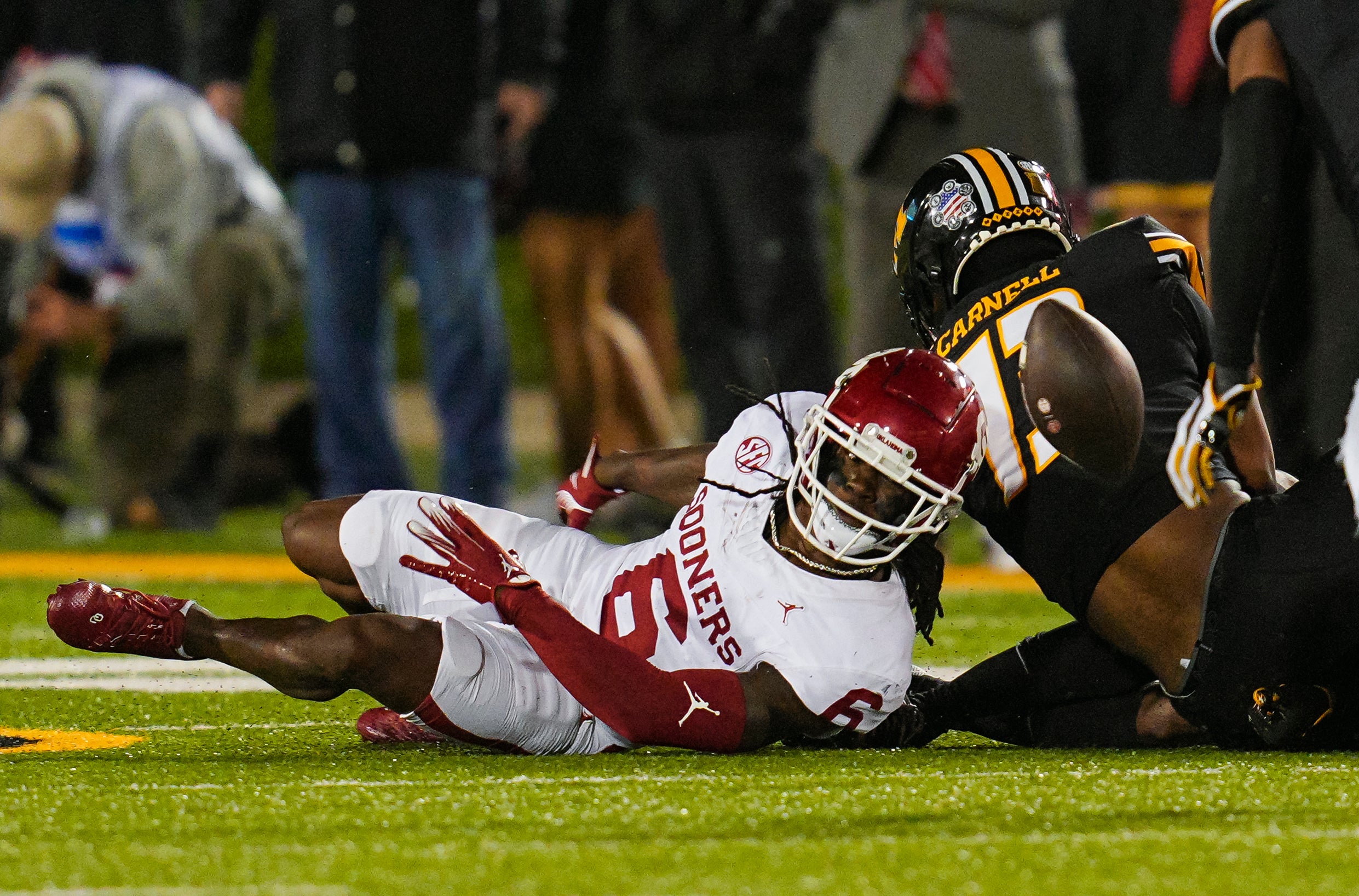 Nov 9, 2024; Columbia, Missouri, USA; Oklahoma Sooners wide receiver Deion Burks (6) fumbles the ball during the second half against the Missouri Tigers at Faurot Field at Memorial Stadium.