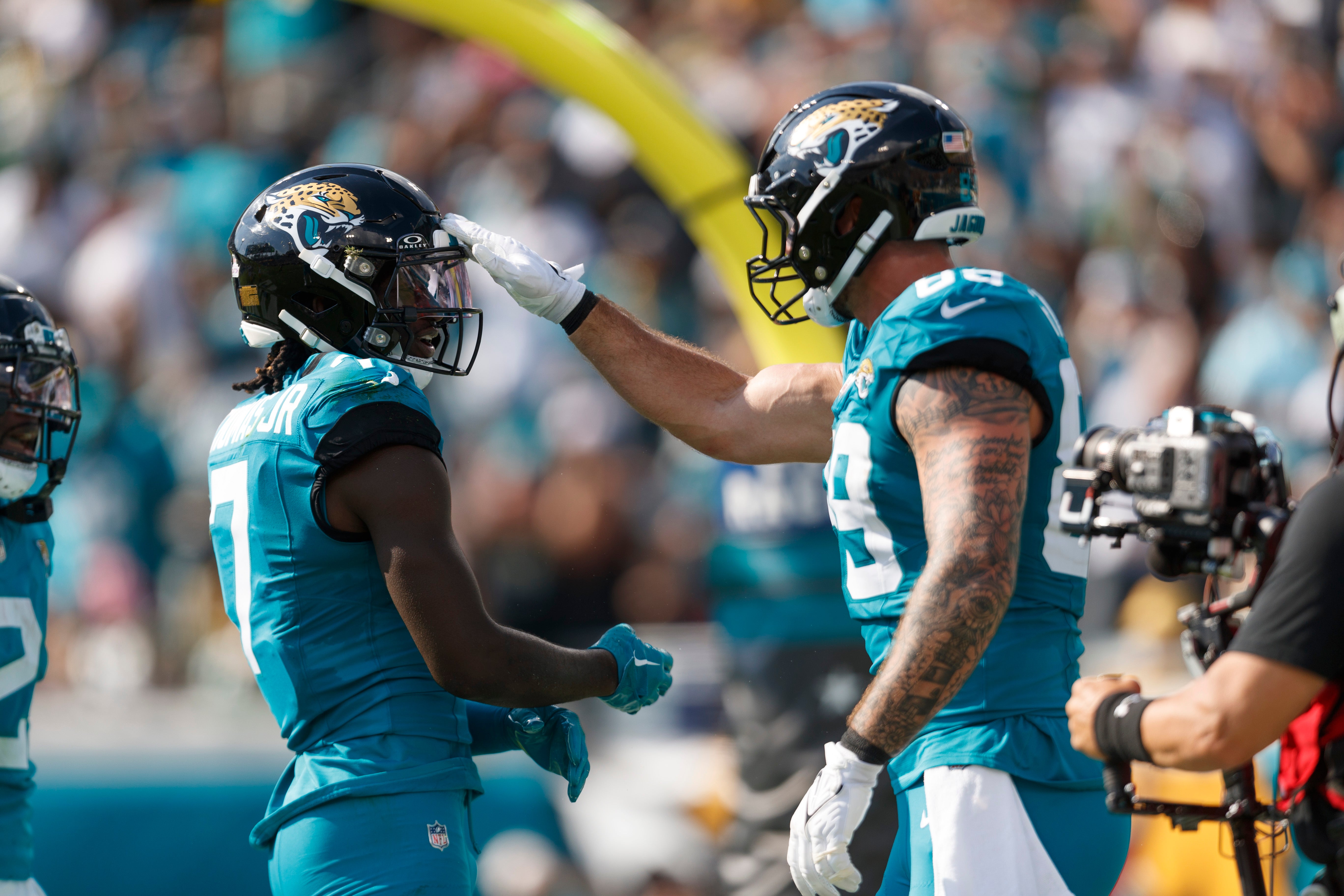 Oct 27, 2024; Jacksonville, Florida, USA; Jacksonville Jaguars wide receiver Brian Thomas Jr. (7) and tight end Luke Farrell (89) celebrate a touchdown against the Green Bay Packers during the third quarter at EverBank Stadium.