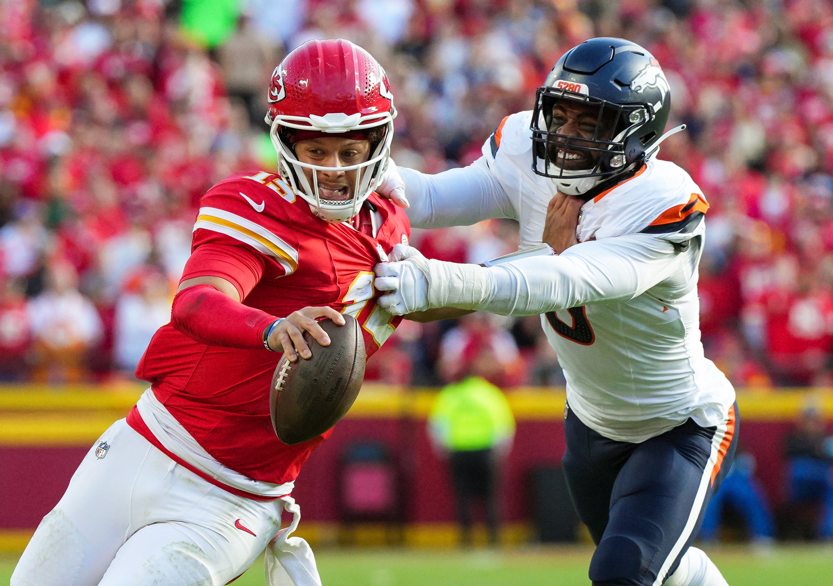 Chiefs quarterback Patrick Mahomes runs the ball against Broncos linebacker Jonathon Cooper.