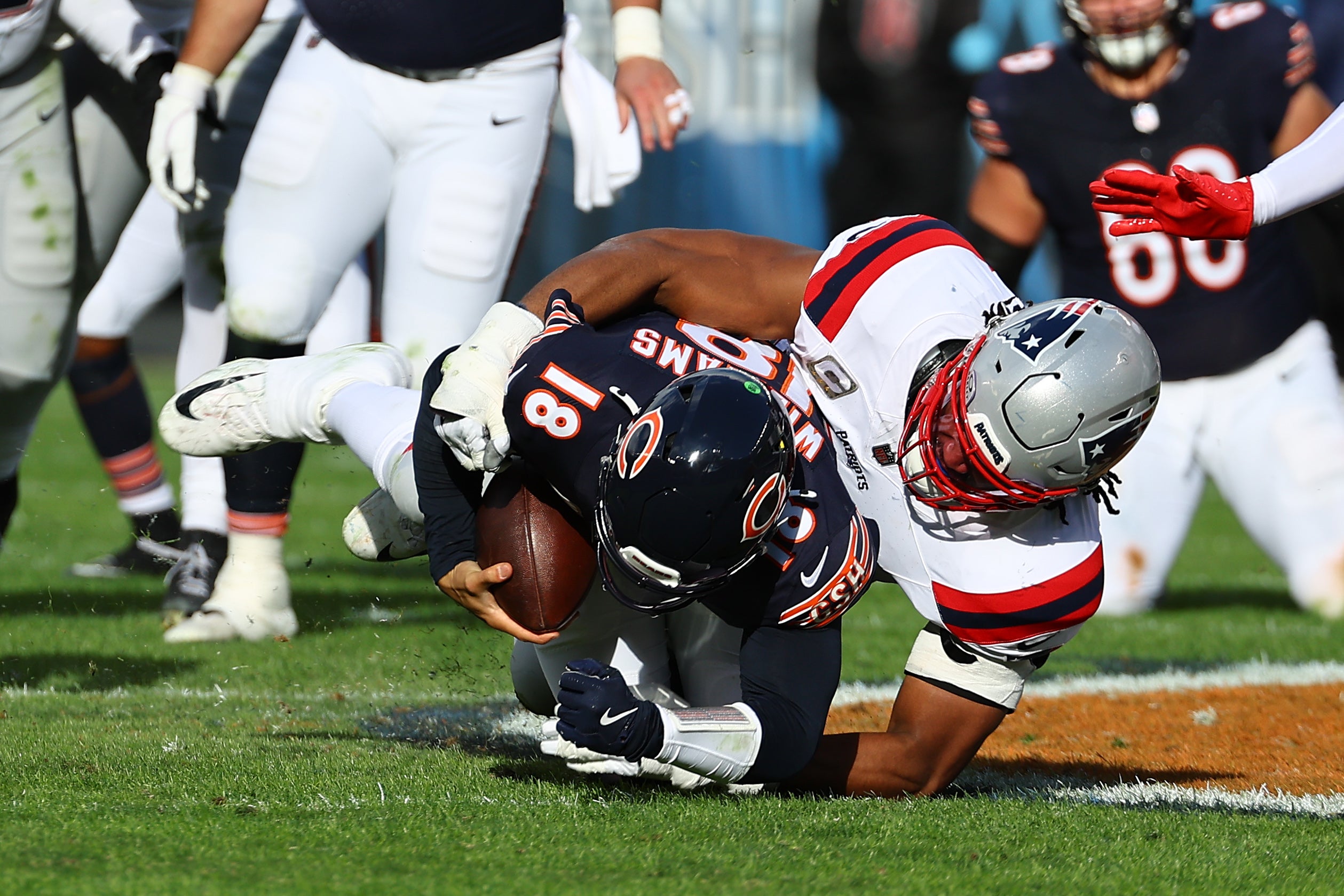 Nov 10, 2024; Chicago, Illinois, USA; New England Patriots defensive end Deatrich Wise Jr. (91) sacks Chicago Bears quarterback Caleb Williams (18) during the second half at Soldier Field.