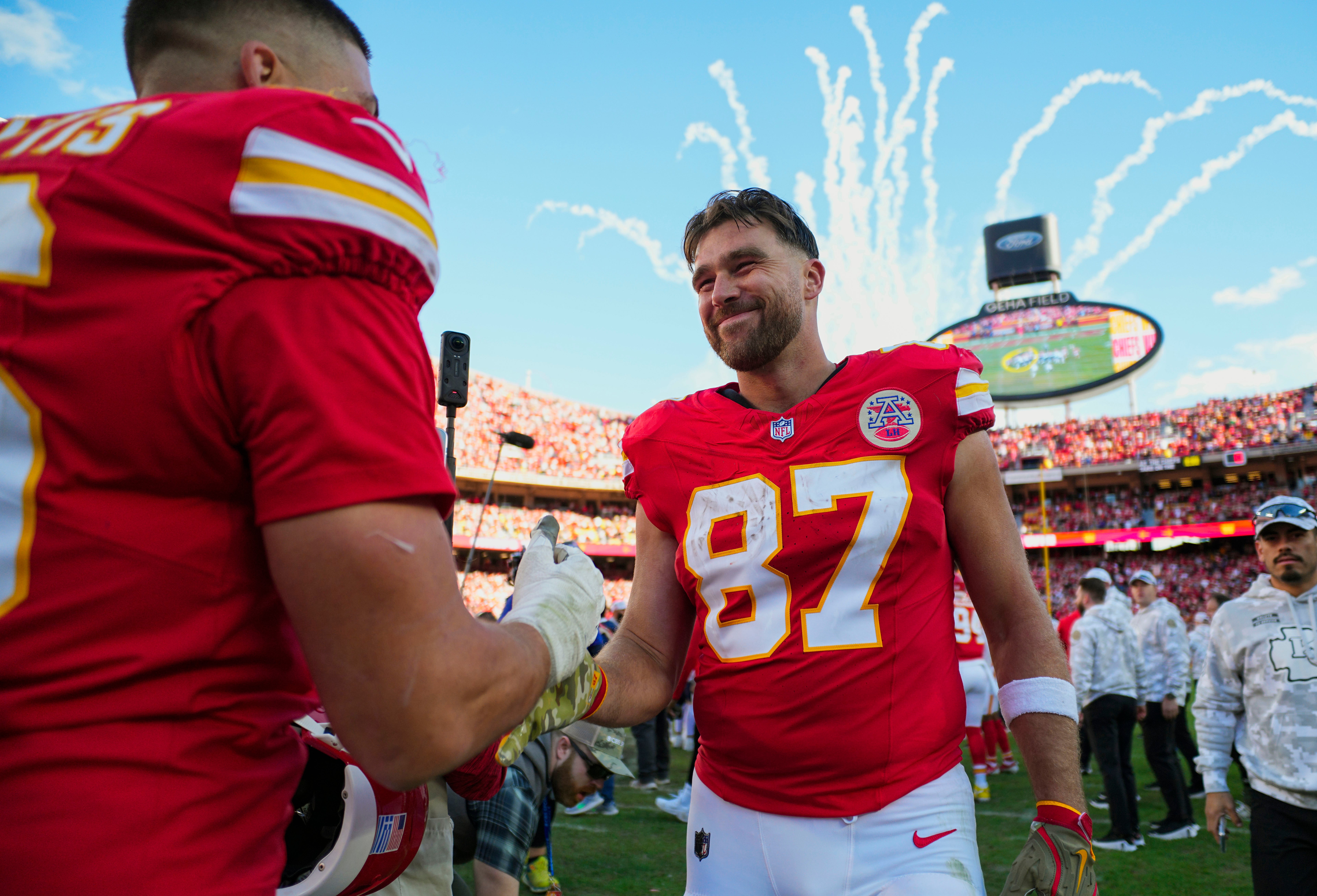 Chiefs tight end Travis Kelce (87) celebrates with defensive end George Karlaftis (56) after defeating the Broncos.