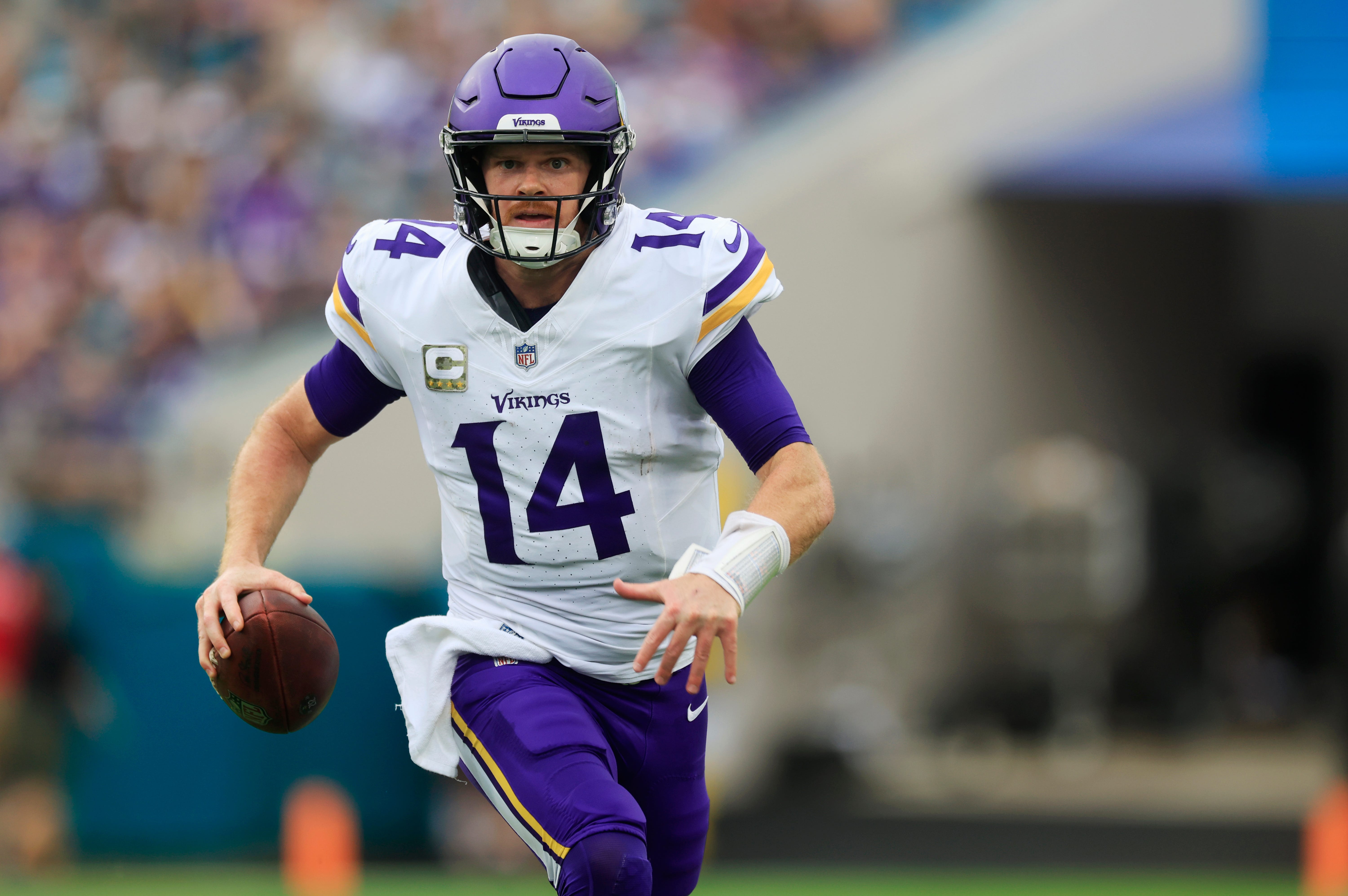 Minnesota Vikings quarterback Sam Darnold (14) is pressured out of the pocket and forced to run during the second quarter an NFL football matchup Sunday, Nov. 10, 2024 at Everbank Stadium in Jacksonville, Fla. The Vikings defeated the Jaguars 12-7.