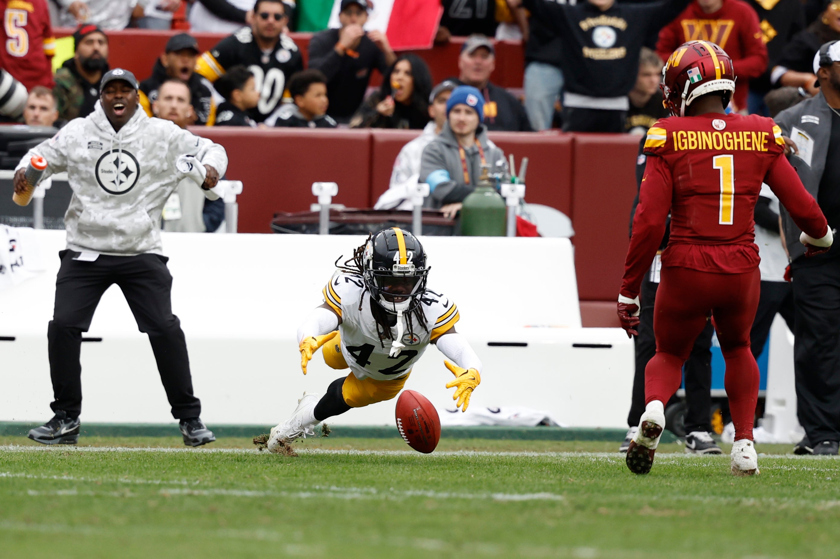 Nov 10, 2024; Landover, Maryland, USA; Pittsburgh Steelers cornerback James Pierre (42) drops a fake punt pass attempt as Washington Commanders cornerback Noah Igbinoghene (1) looks on during the first half at Northwest Stadium.