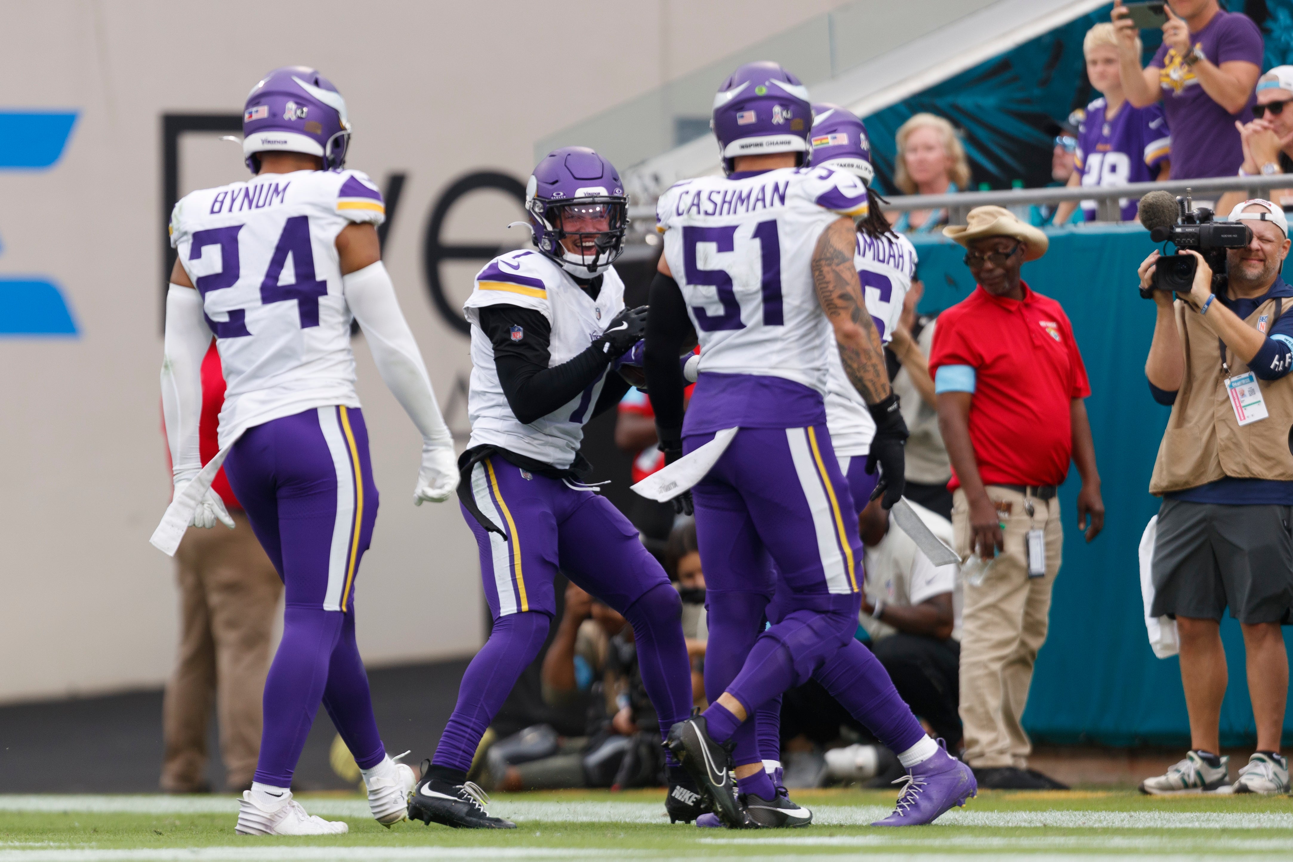 Nov 10, 2024; Jacksonville, Florida, USA; Minnesota Vikings cornerback Shaq Griffin (1) celebrates an interception with safety Camryn Bynum (24), linebacker Blake Cashman (51), and linebacker Brian Asamoah II (6) against the Jacksonville Jaguars during the fourth quarter at EverBank Stadium.