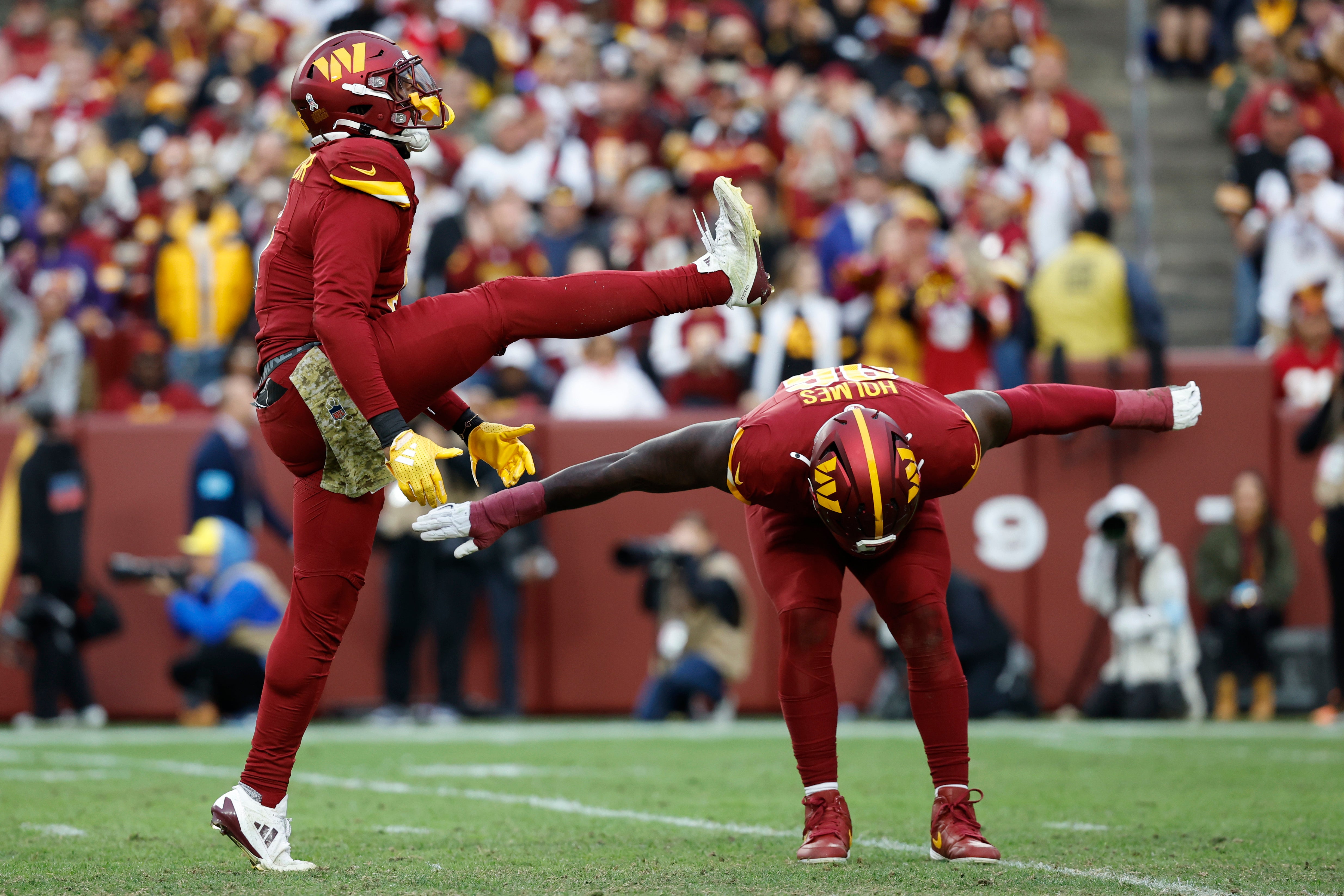 Nov 10, 2024; Landover, Maryland, USA; Washington Commanders linebacker Dante Fowler Jr. (6) and Commanders defensive tackle Jalyn Holmes (96) celebrate after a sack of Pittsburgh Steelers quarterback Russell Wilson (not pictured) during the second half at Northwest Stadium.