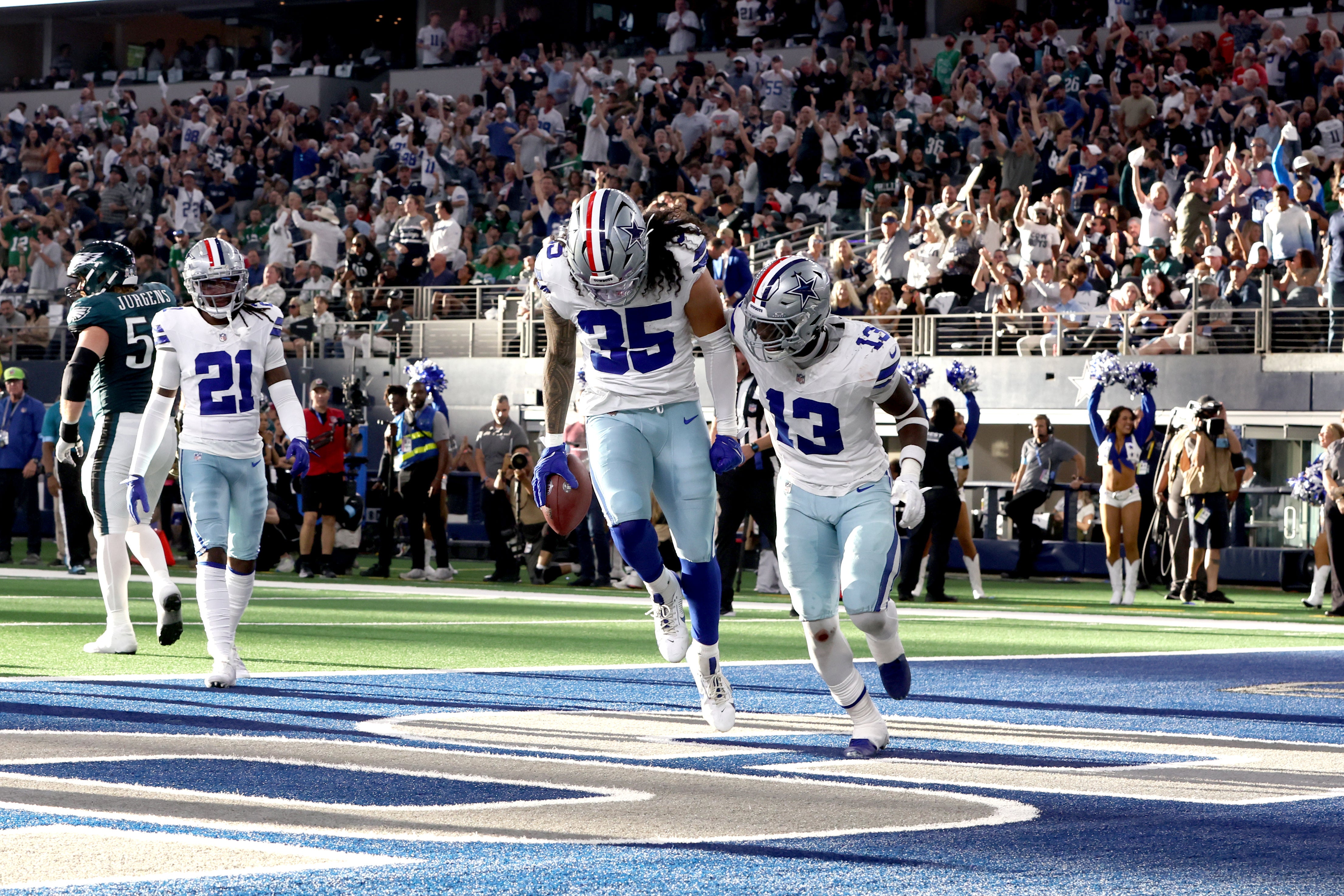 Dallas Cowboys linebacker Marist Liufau (35) and linebacker DeMarvion Overshown (13) react to recovering a fumble in the second quarter against the Philadelphia Eagles at AT&T Stadium.
