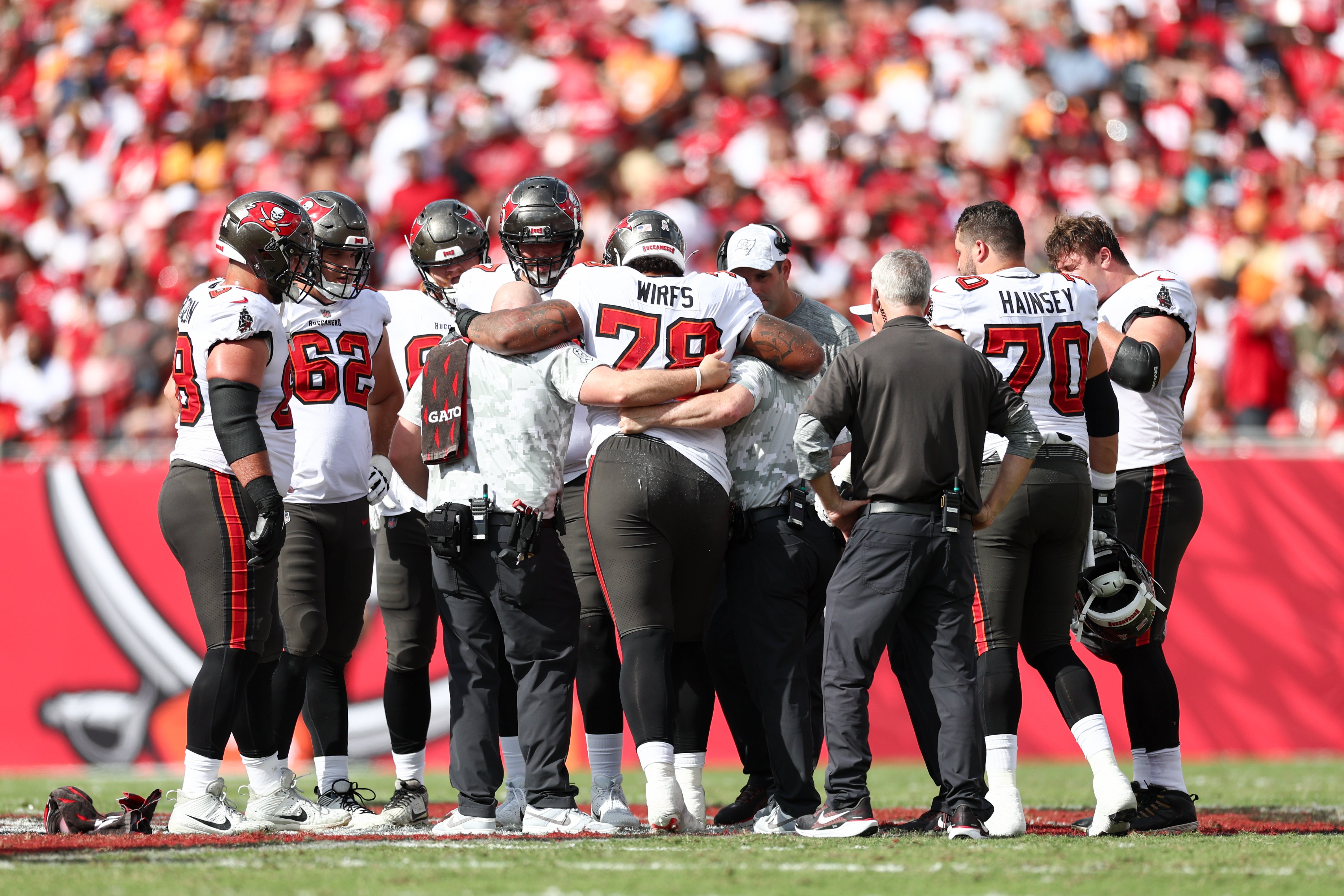 Nov 10, 2024; Tampa, Florida, USA; Tampa Bay Buccaneers offensive tackle Tristan Wirfs (78) is helped off the field by staff against the San Francisco 49ers in the second quarter at Raymond James Stadium.
