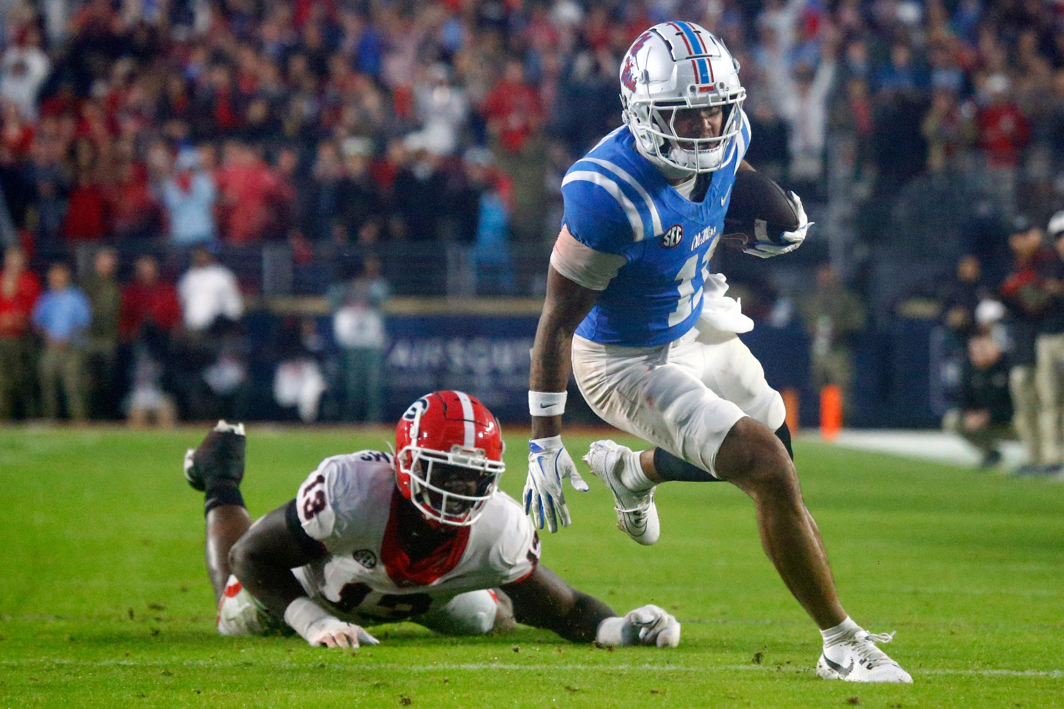 Nov 9, 2024; Oxford, Mississippi, USA; Mississippi Rebels wide receiver Jordan Watkins (11) breaks a tackle attempt by Georgia Bulldogs defensive lineman Mykel Williams (13), after a catch during the second half at Vaught-Hemingway Stadium.
