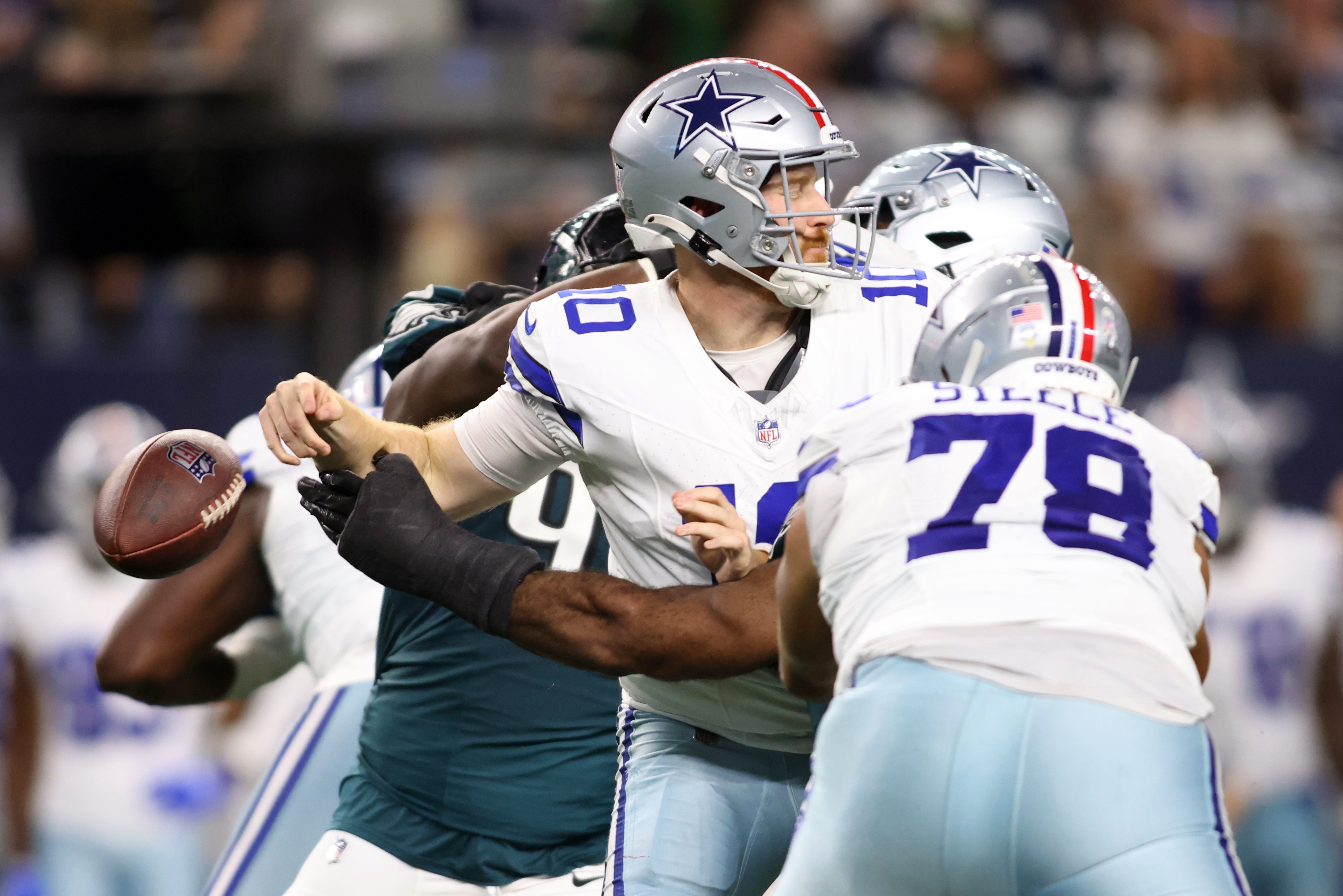 Dallas Cowboys quarterback Cooper Rush (10) fumbles the ball against the Philadelphia Eagles in the third quarter at AT&T Stadium.