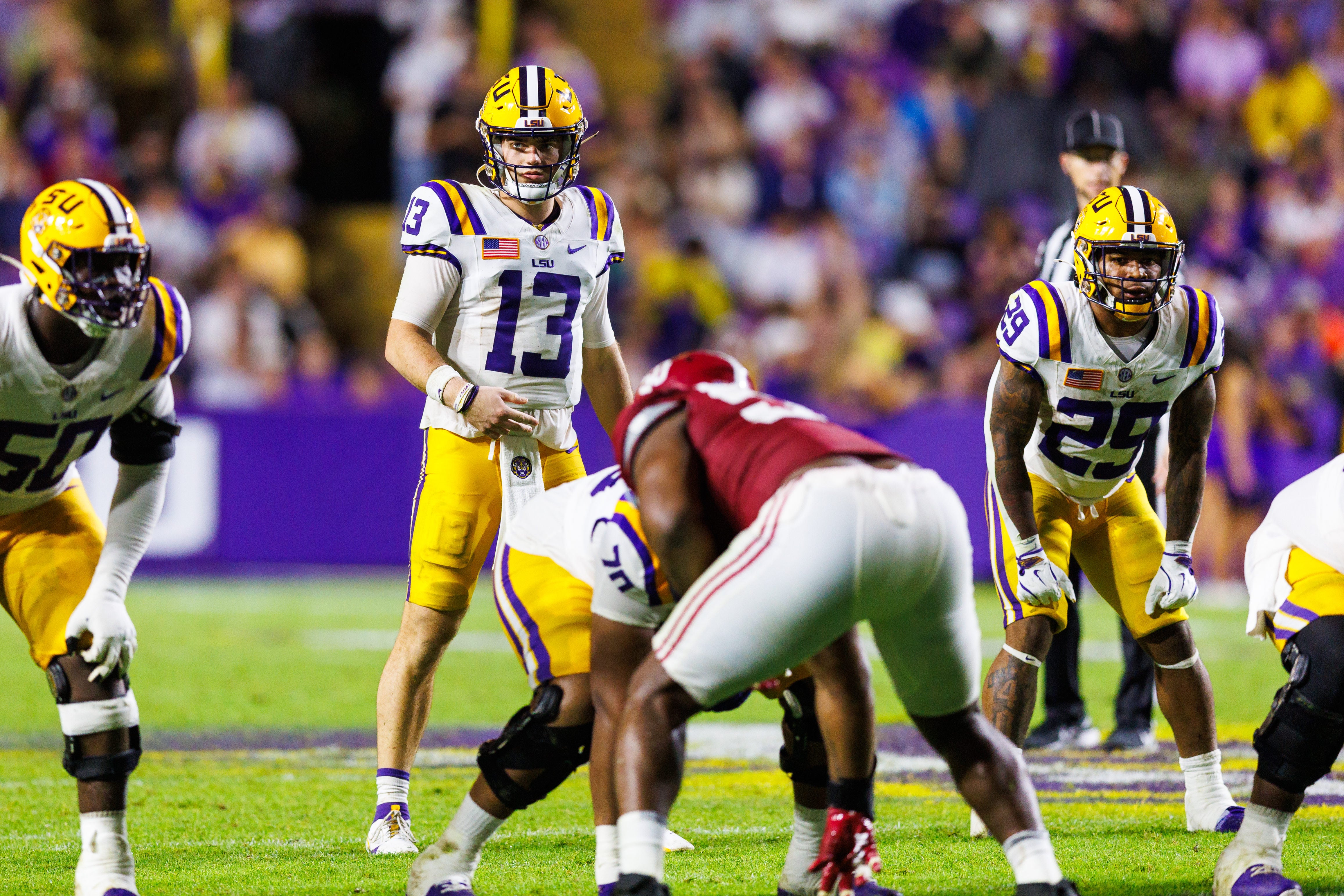 LSU Tigers quarterback Garrett Nussmeier (13) looks over the Alabama Crimson Tide defense during the second half at Tiger Stadium.