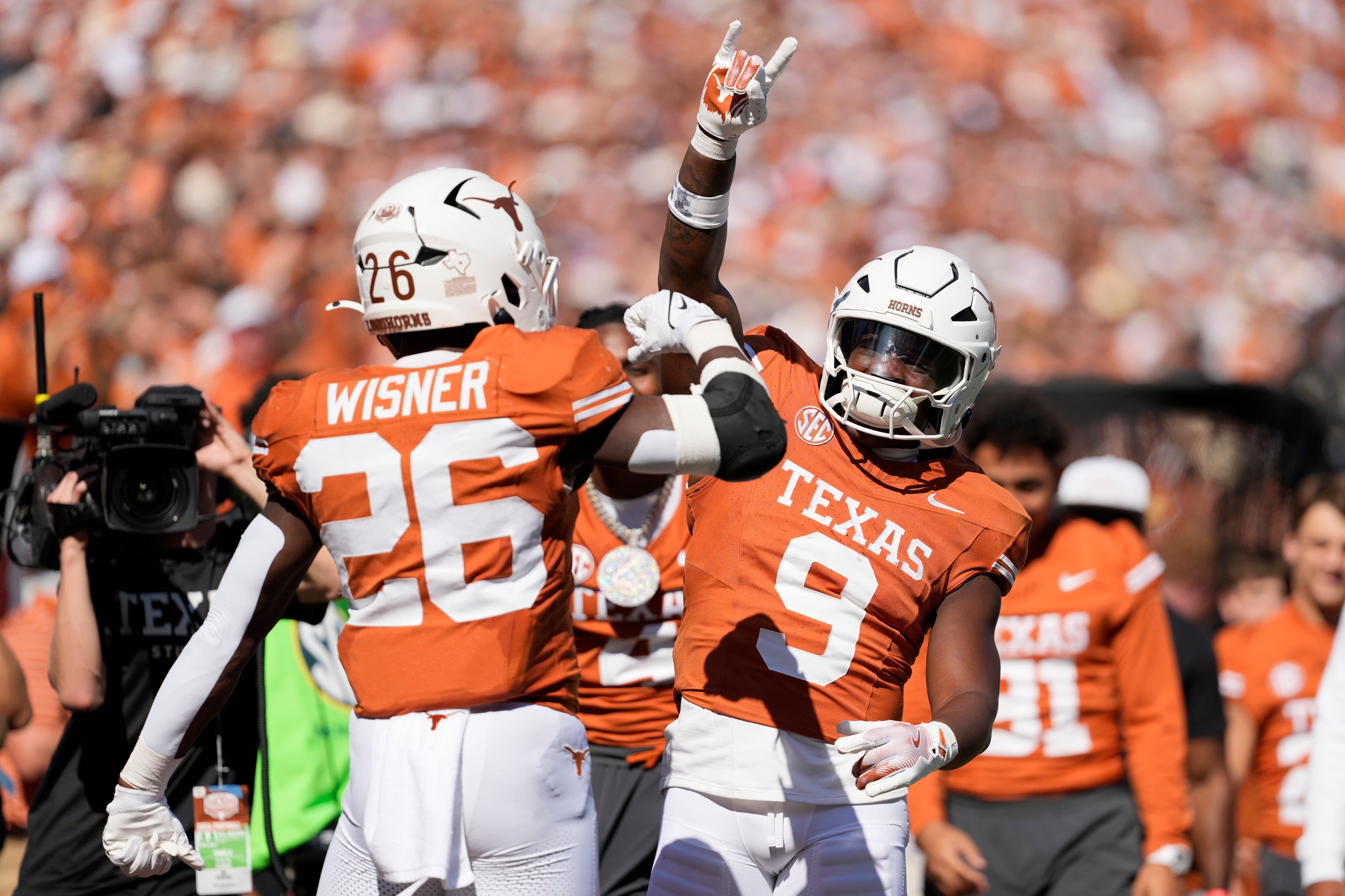 Texas Longhorns running back Quintrevion Wisner (26) celebrates with Jerrick Gibson (9) after scoring a touchdown during the first half against the Florida Gators at Darrell K Royal-Texas Memorial Stadium.