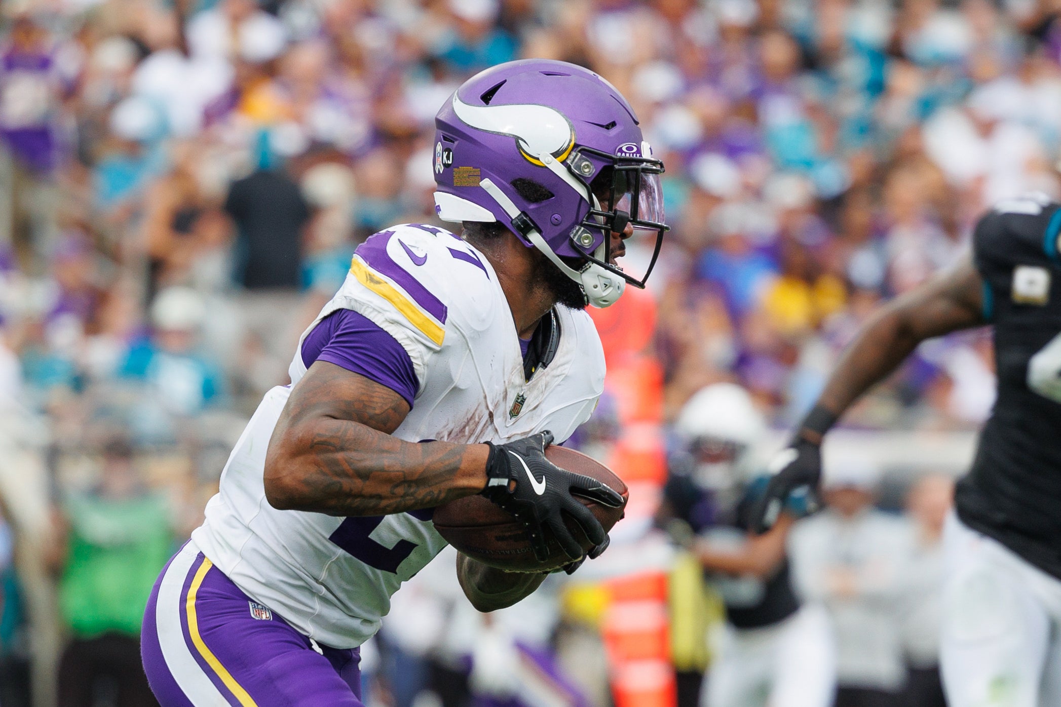 Nov 10, 2024; Jacksonville, Florida, USA; Minnesota Vikings running back Cam Akers (27) runs with the ball against the Jacksonville Jaguars during the fourth quarter at EverBank Stadium.