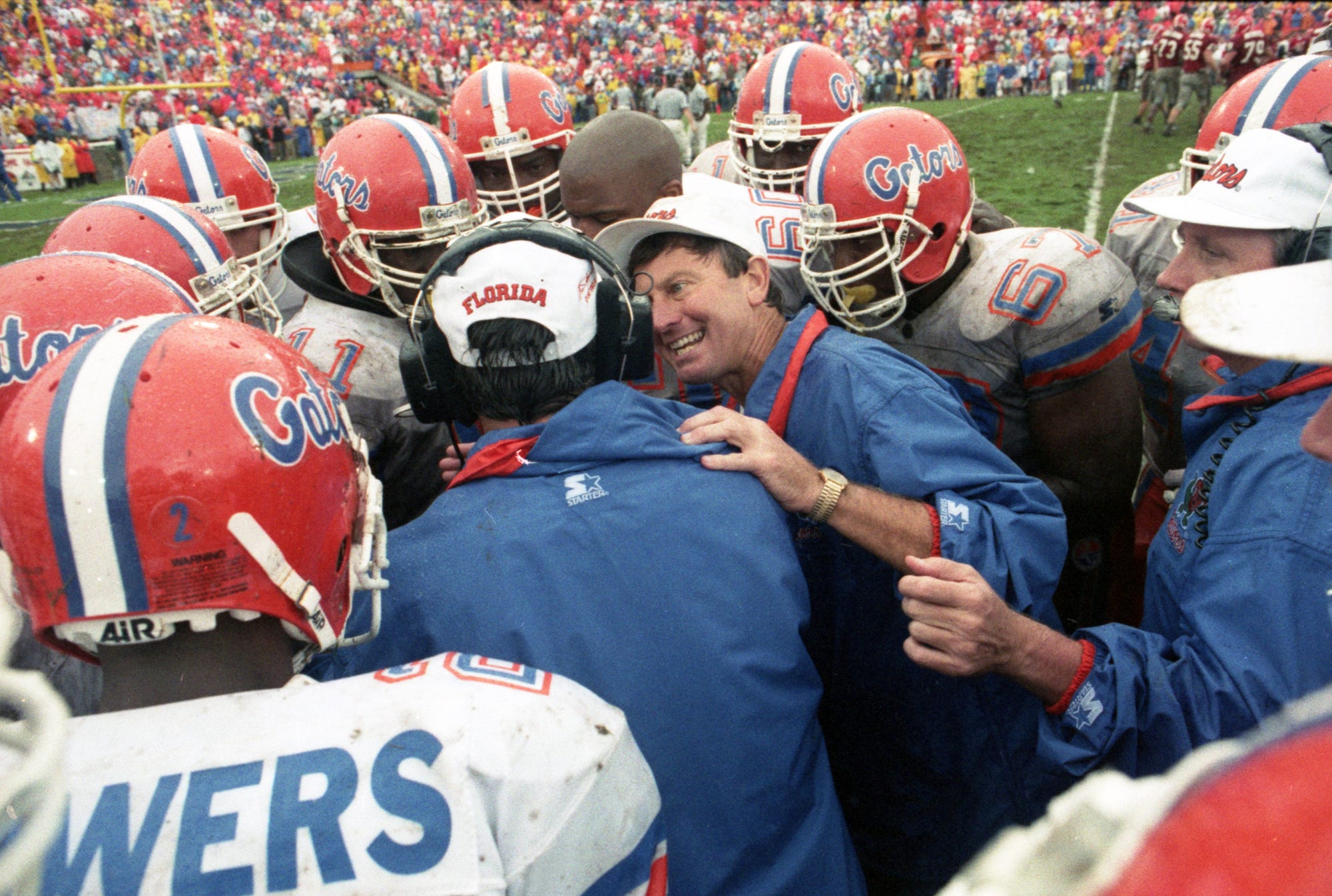 10/30/93...University of Florida Head Coach Steve Spurrier talks to his defense prior to the last play of the 1993 Florida/Georgia football game, the last Florida/Georgia game played in the old Gator Bowl and played in a driving rain. Cornerback Anthone Lott called a timeout that nullified a game-tying Georgia touchdown. Georgia lost their chance for a last-second victory when a pass thrown by Georgia's Eric Zeier bounced off the hands of Georgia wide receiver Jeff Thomas in the end zone giving the Gators a 33 to 26 victory over the Bulldogs.