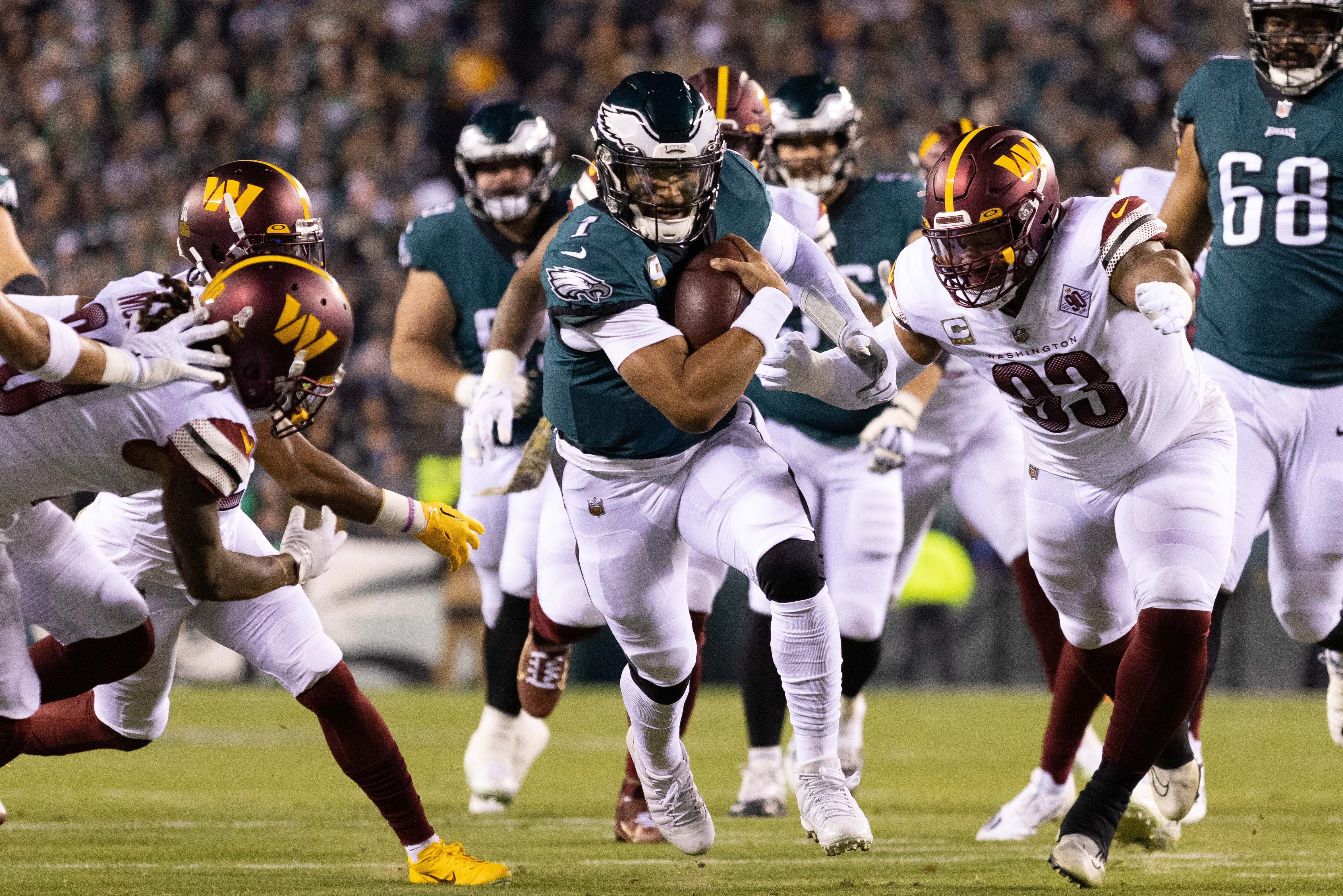 Philadelphia Eagles quarterback Jalen Hurts (1) runs with the ball against the Washington Commanders during the first quarter at Lincoln Financial Field.
