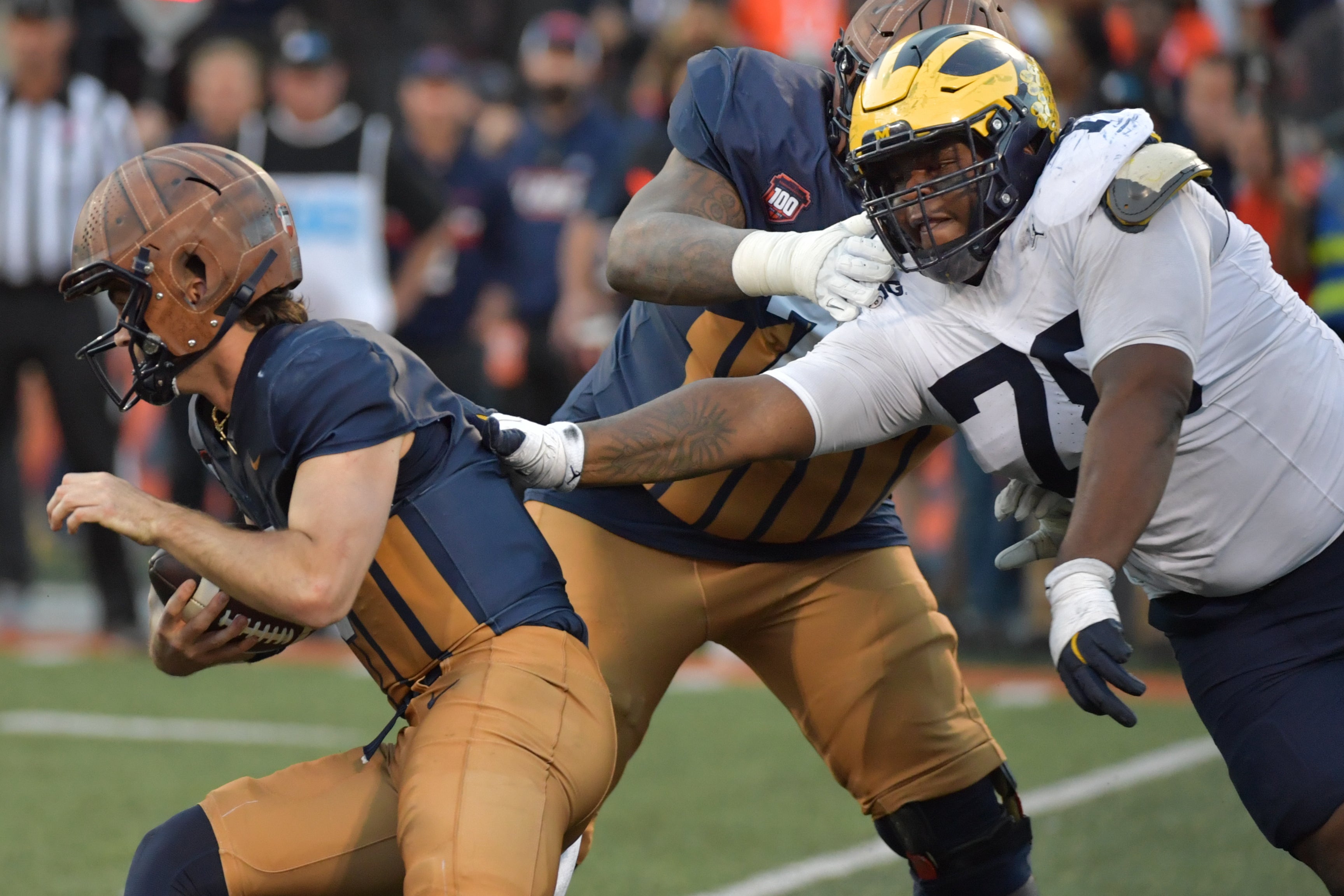 Oct 19, 2024; Champaign, Illinois, USA; Michigan Wolverines defensive lineman Kenneth Grant (78) reaches for Illinois Fighting Illini quarterback Luke Altmyer (9) during the second half at Memorial Stadium.