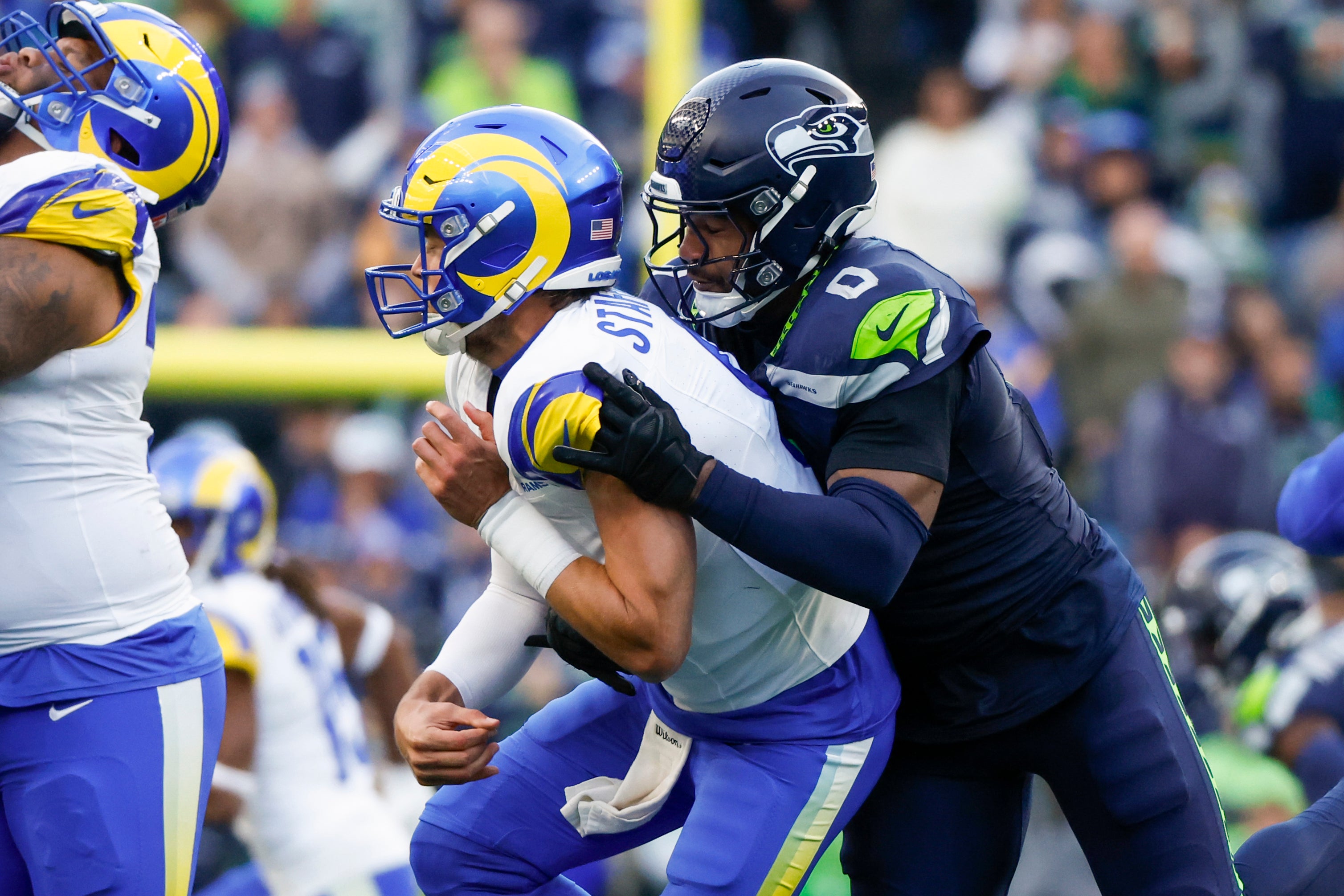 Seattle Seahawks linebacker Tyrel Dodson (0) pressures Los Angeles Rams quarterback Matthew Stafford (9) during the third quarter at Lumen Field.