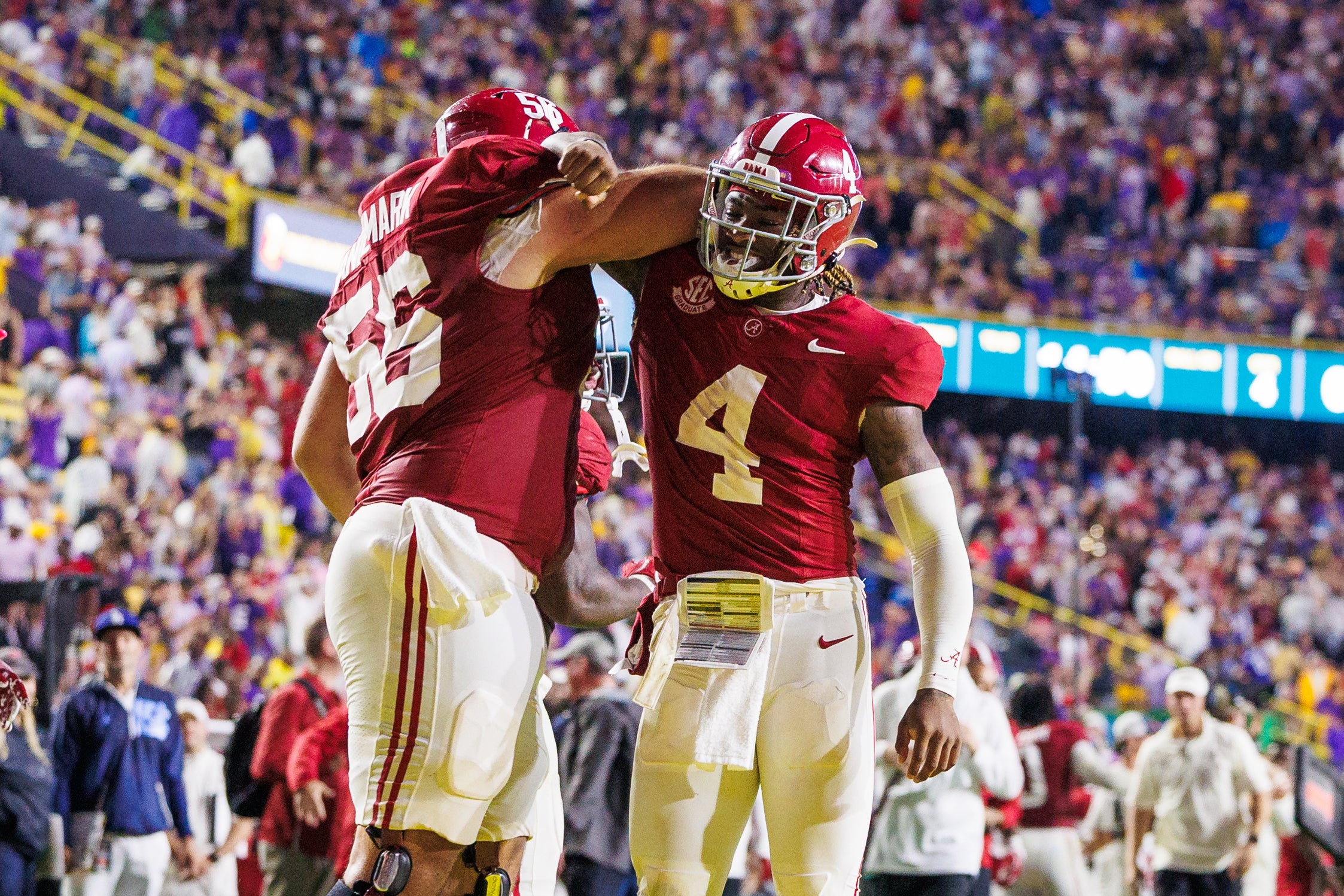 Nov 9, 2024; Baton Rouge, Louisiana, USA; Alabama Crimson Tide quarterback Jalen Milroe (4) celebrates a touchdown with offensive lineman Geno VanDeMark (56) against the LSU Tigers during the second half at Tiger Stadium.