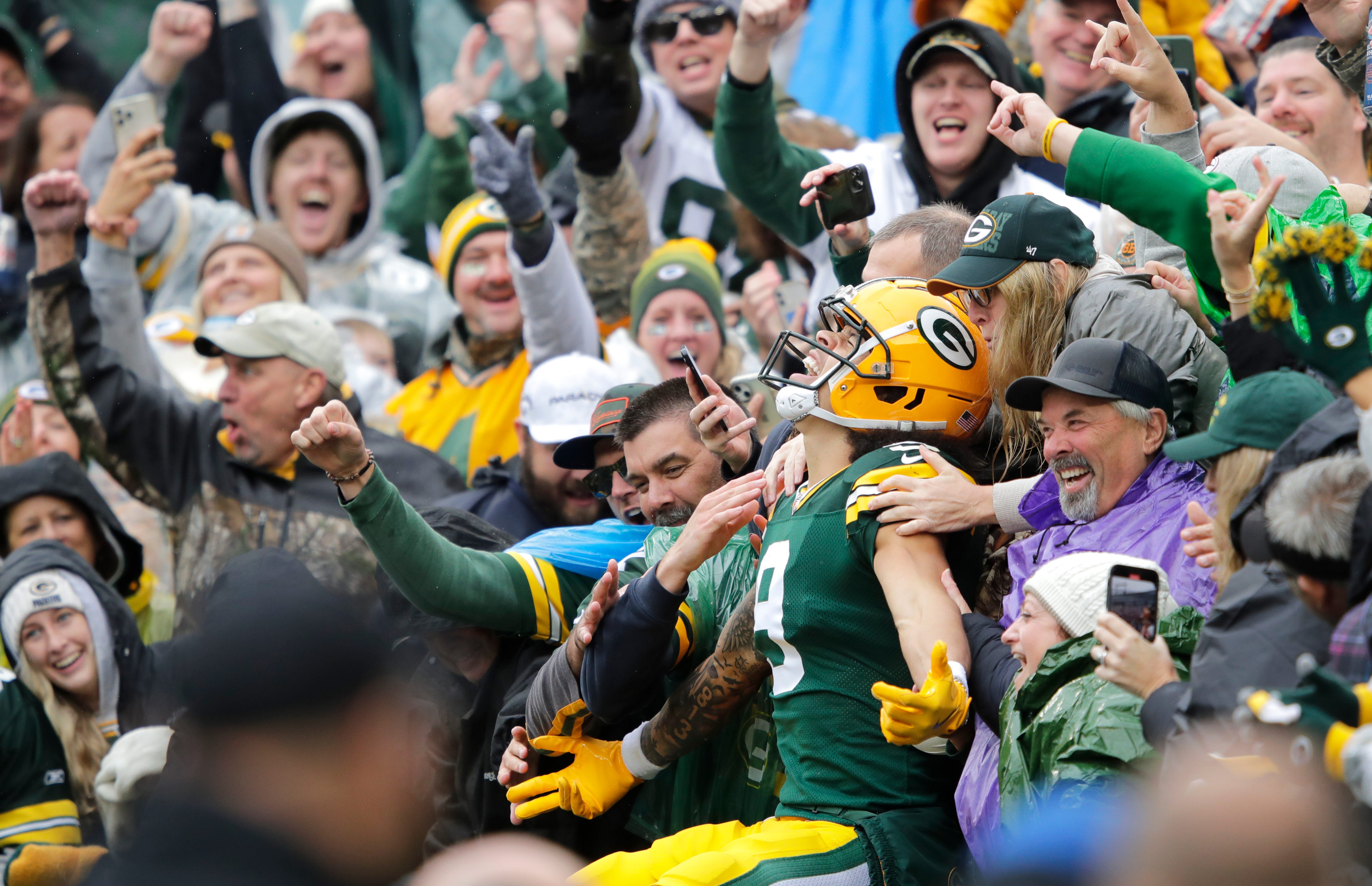 Green Bay Packers wide receiver Christian Watson (9) celebrates scoring a touchdown with a Lambeau Leap in the second quarter agains the Arizona Cardinals during their football game Sunday, October 13, 2024, at Lambeau Field in Green Bay, Wisconsin.