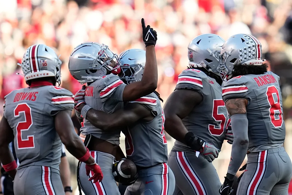 Ohio State Buckeyes cornerback Davison Igbinosun (1) celebrates his first interception during the second half of the NCAA football game against the Iowa Hawkeyes at Ohio Stadium. Ohio State won 35-7