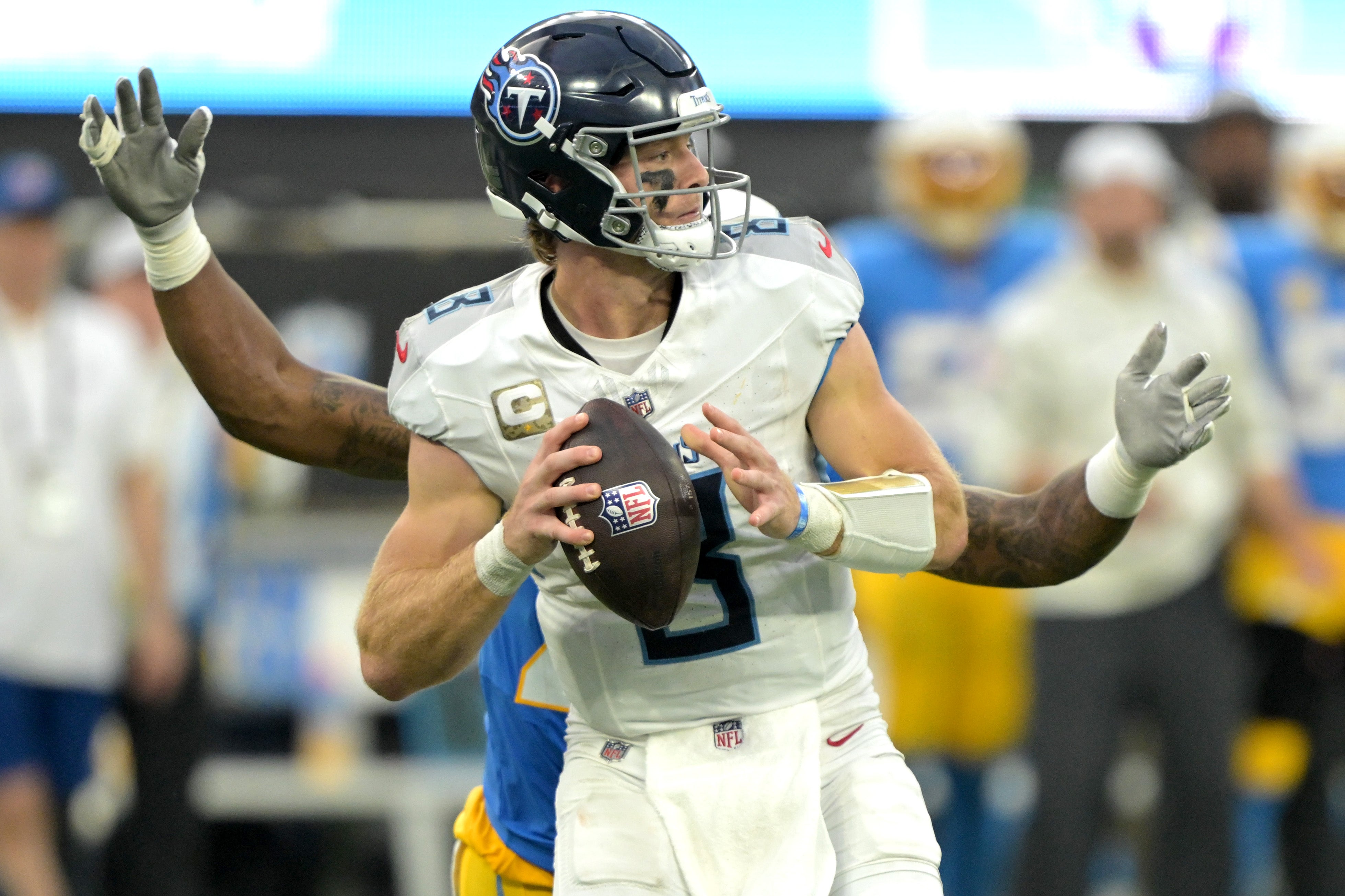 Nov 10, 2024; Inglewood, California, USA; Tennessee Titans quarterback Will Levis (8) is sacked by Los Angeles Chargers linebacker Bud Dupree (48) in the second half at SoFi Stadium. Mandatory Credit: Jayne Kamin-Oncea-Imagn Images