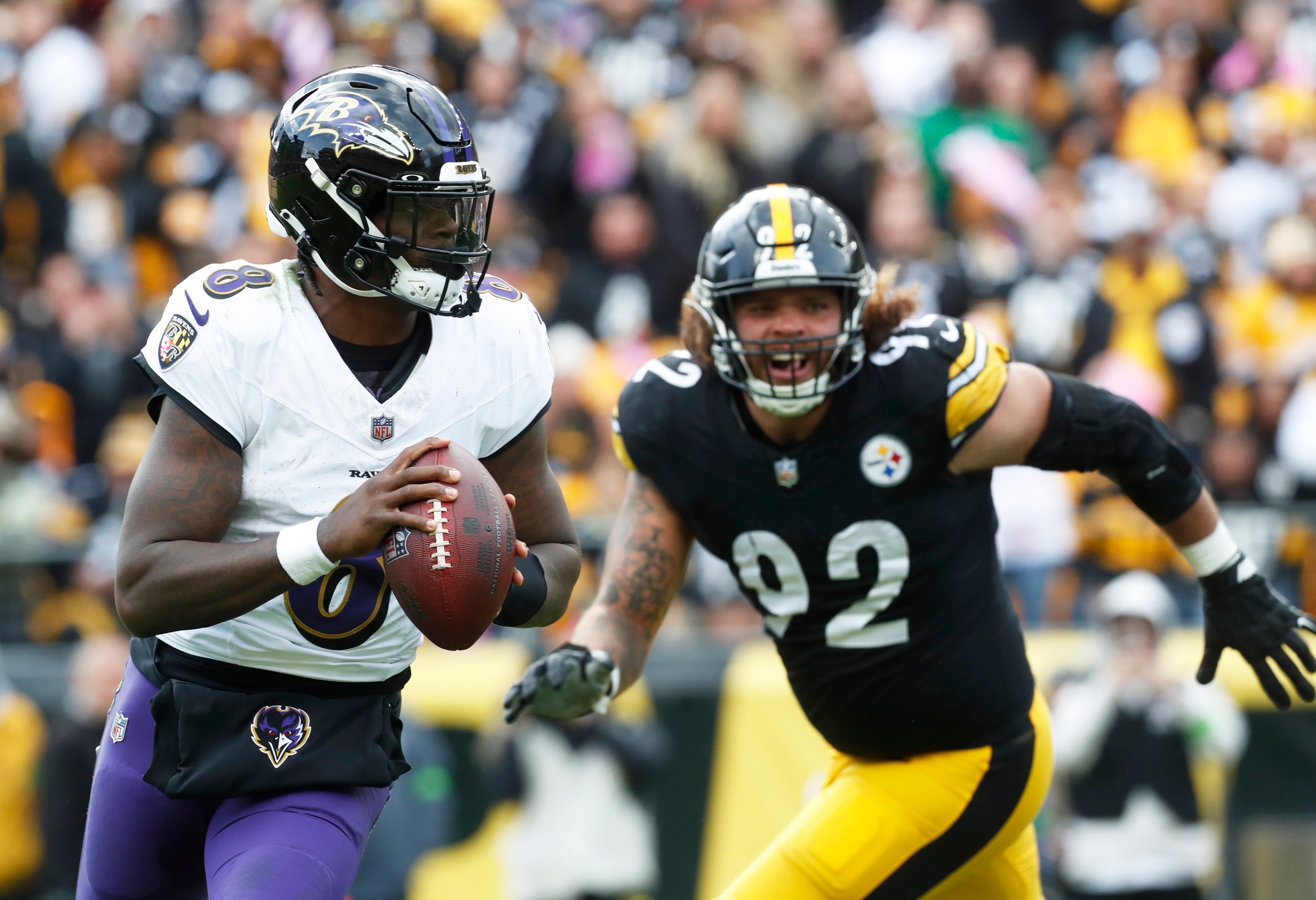 Baltimore Ravens quarterback Lamar Jackson (8) scrambles with the ball against the Pittsburgh Steelers during the fourth quarter at Acrisure Stadium.