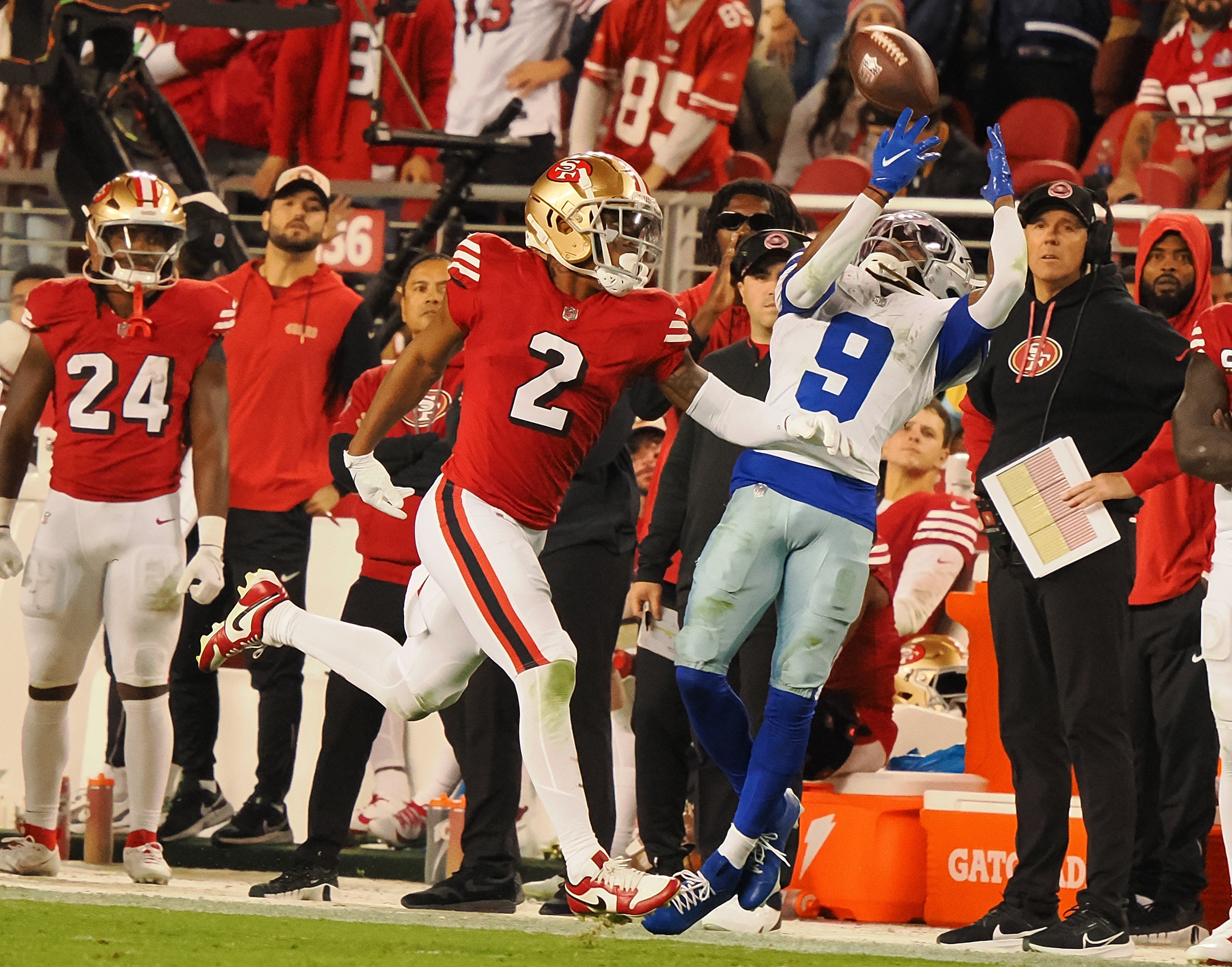 San Francisco 49ers defensive back Deommodore Lenoir (2) prevents the pass intended fo rDallas Cowboys wide receiver KaVonte Turpin (9) as San Francisco 49ers quarterback Brock Purdy (13) watches from the bench during the fourth quarter at Levi's Stadium.
