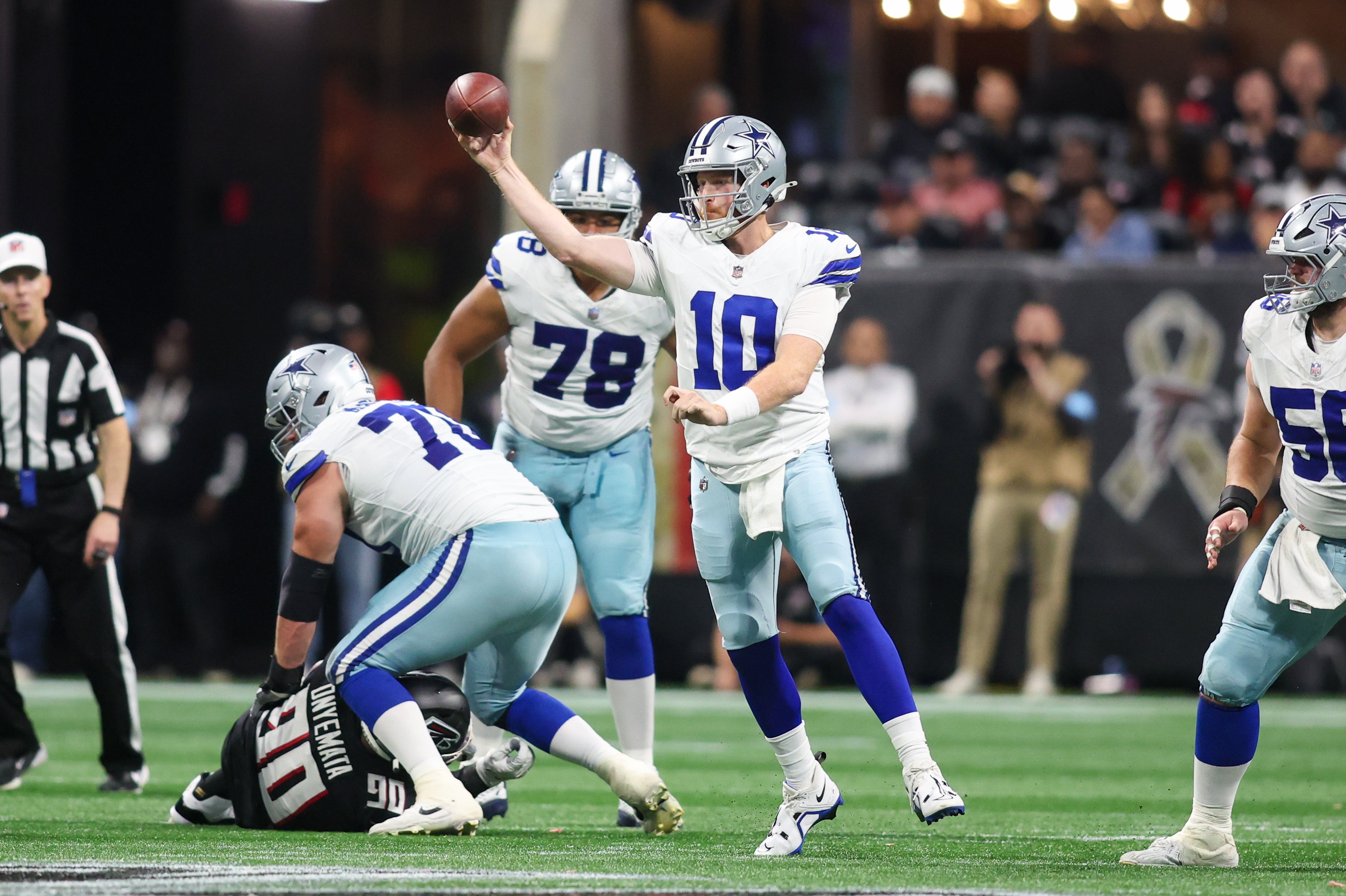 Dallas Cowboys quarterback Cooper Rush (10) throws a pass against the Atlanta Falcons in the fourth quarter at Mercedes-Benz Stadium.