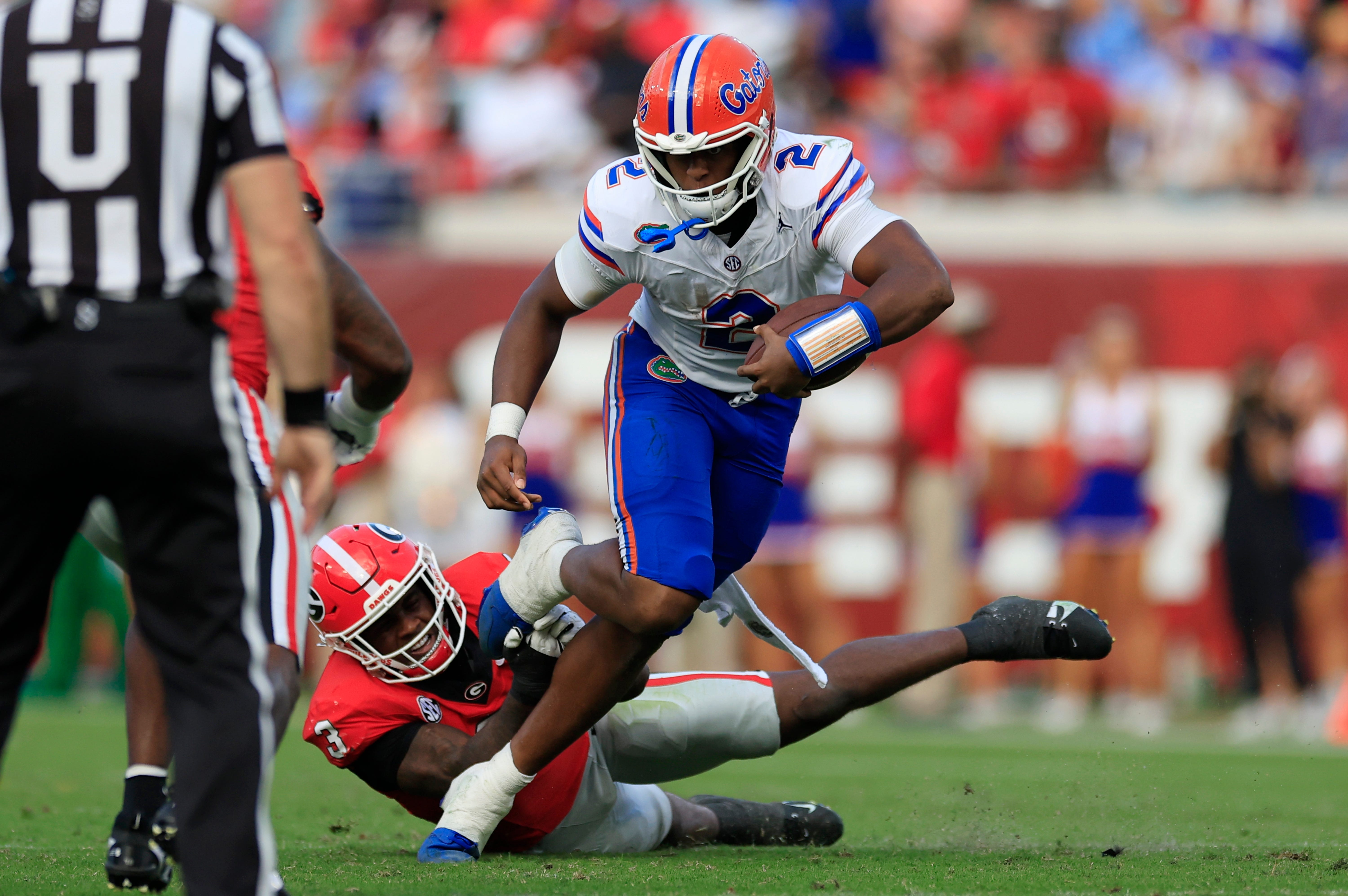 Florida Gators quarterback DJ Lagway (2) rushes for yards against Georgia Bulldogs linebacker CJ Allen (3) during the second quarter of an NCAA college football matchup Saturday, Nov. 2, 2024 at EverBank Stadium in Jacksonville, Fla. The Georgia Bulldogs defeated the Florida Gators 34-20.