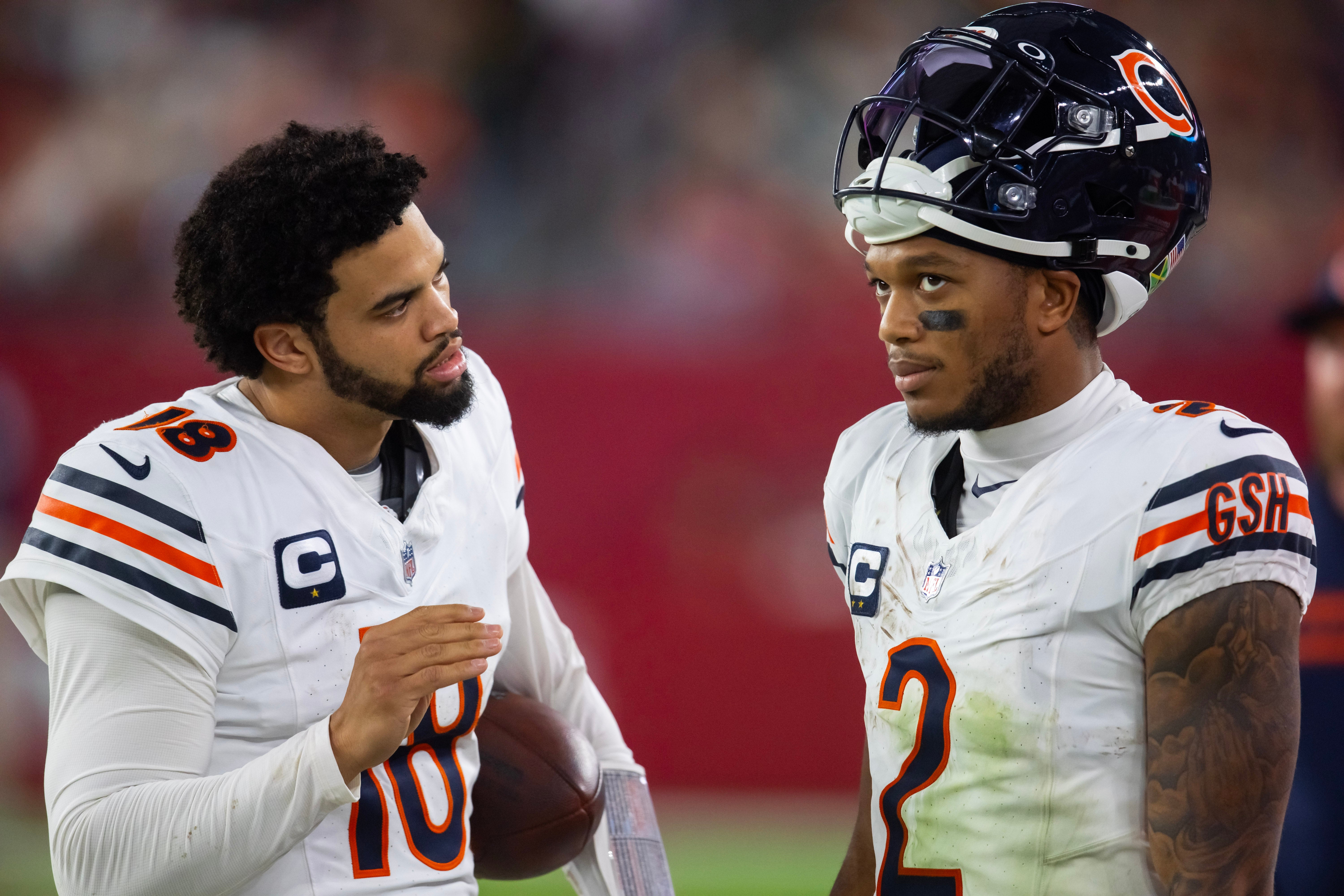 Nov 3, 2024; Glendale, Arizona, USA; Chicago Bears quarterback Caleb Williams (18) talks with wide receiver DJ Moore (2) against the Arizona Cardinals at State Farm Stadium.