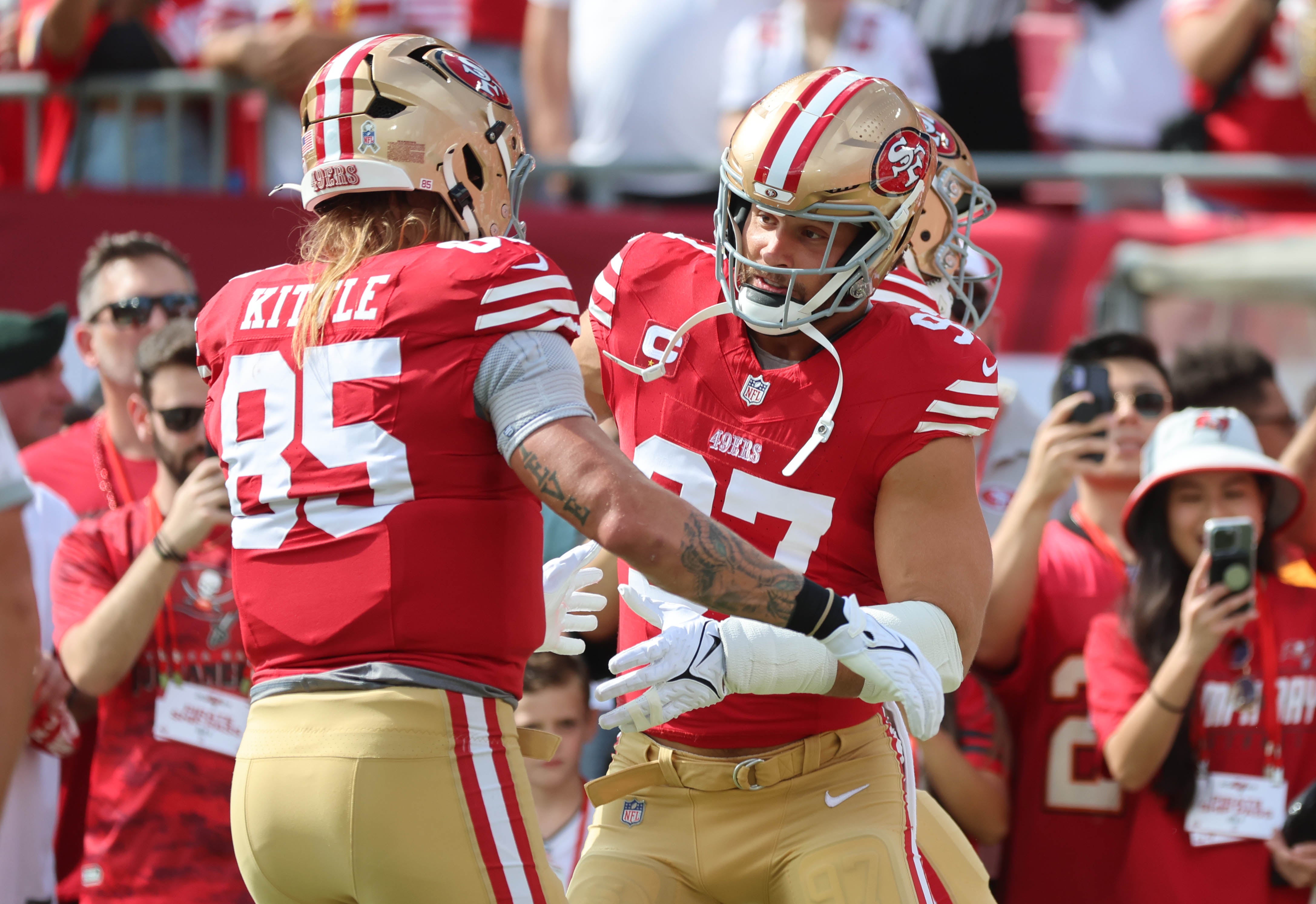 San Francisco 49ers tight end George Kittle (85) and defensive end Nick Bosa (97) prior to the game against the Tampa Bay Buccaneers at Raymond James Stadium.