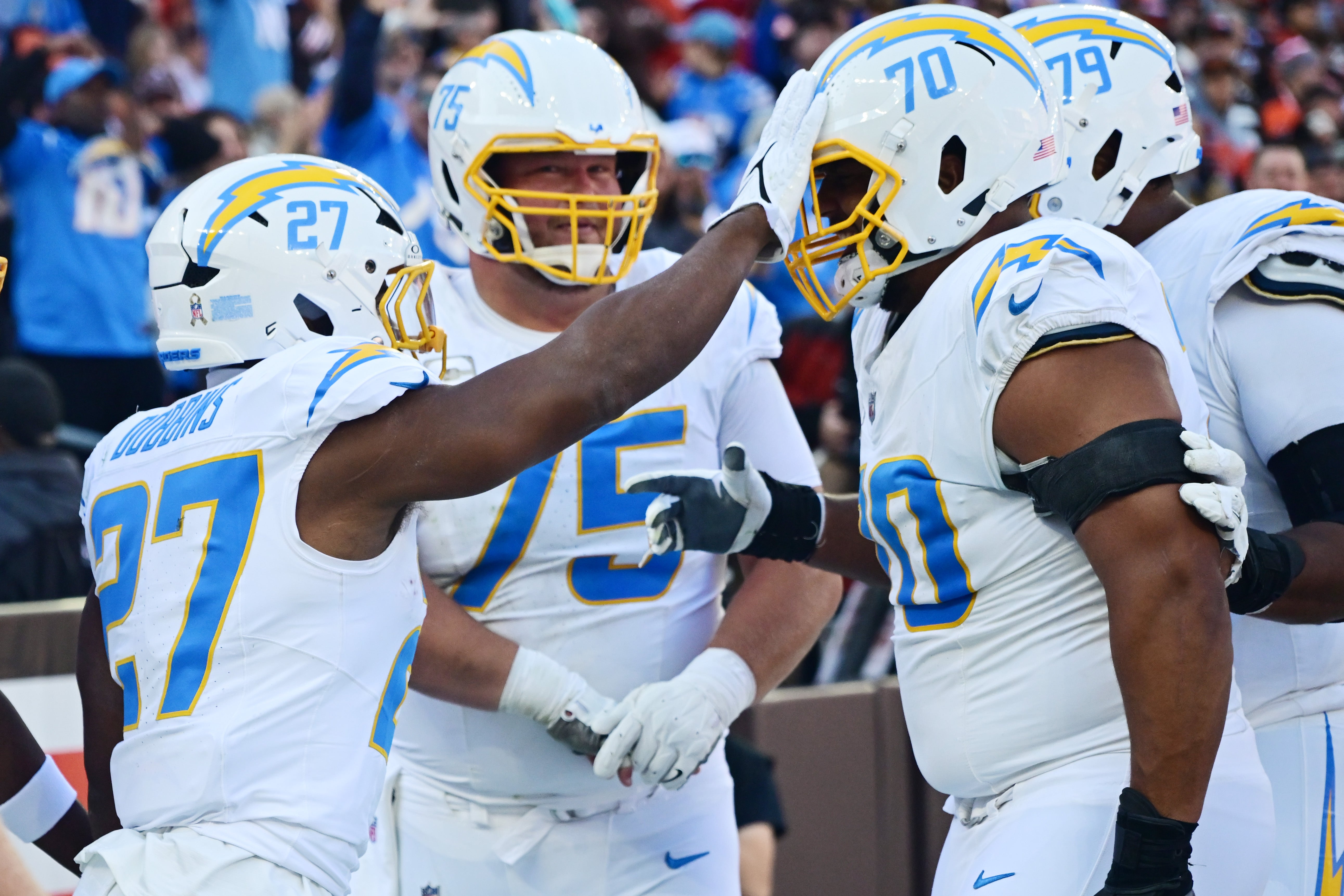 Chargers running back J.K. Dobbins (27) celebrates with offensive tackle Rashawn Slater (70) after scoring a touchdown