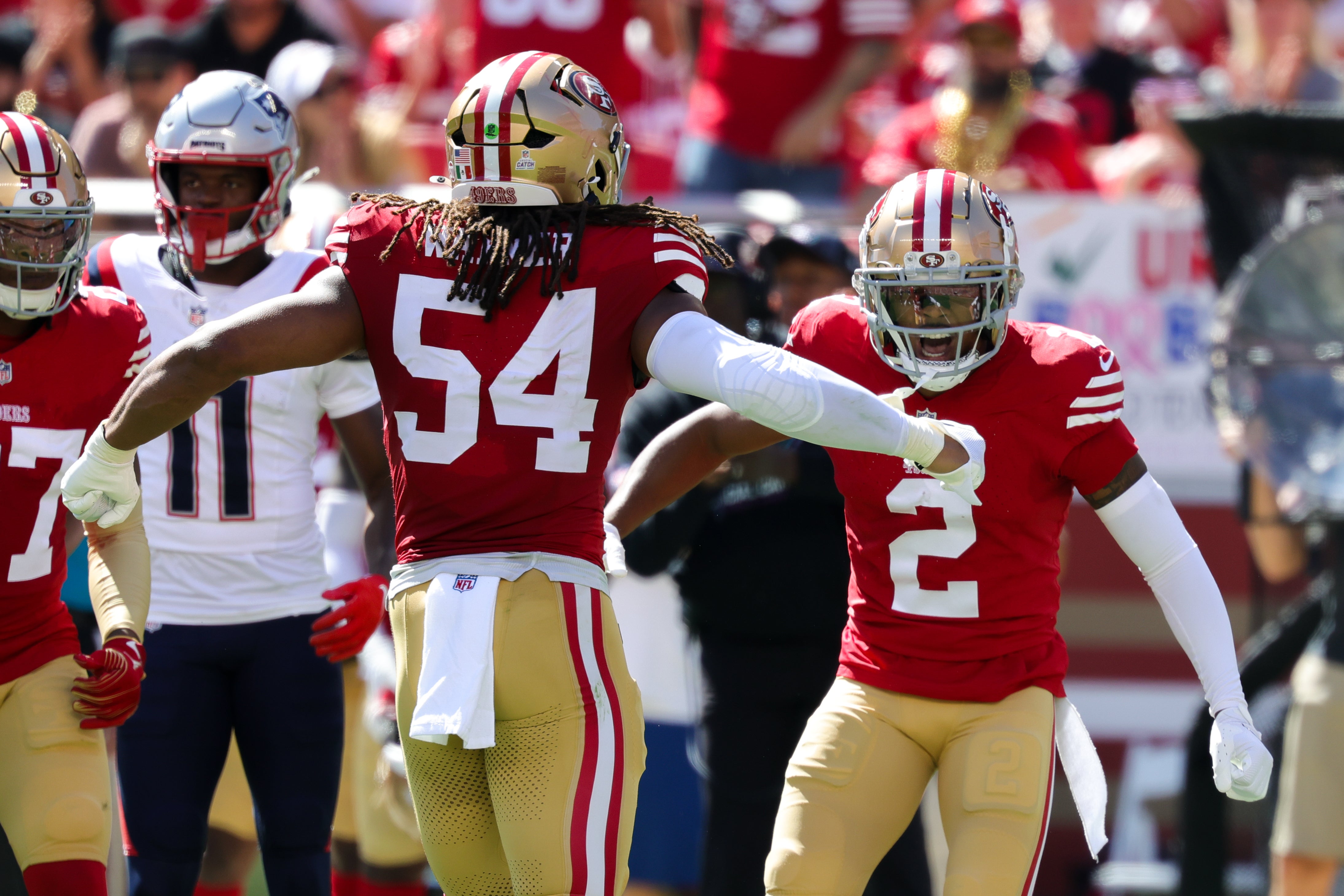 San Francisco 49ers cornerback Deommodore Lenoir (2) celebrates with linebacker Fred Warner (54) after a play against the New England Patriots during the first quarter at Levi's Stadium.