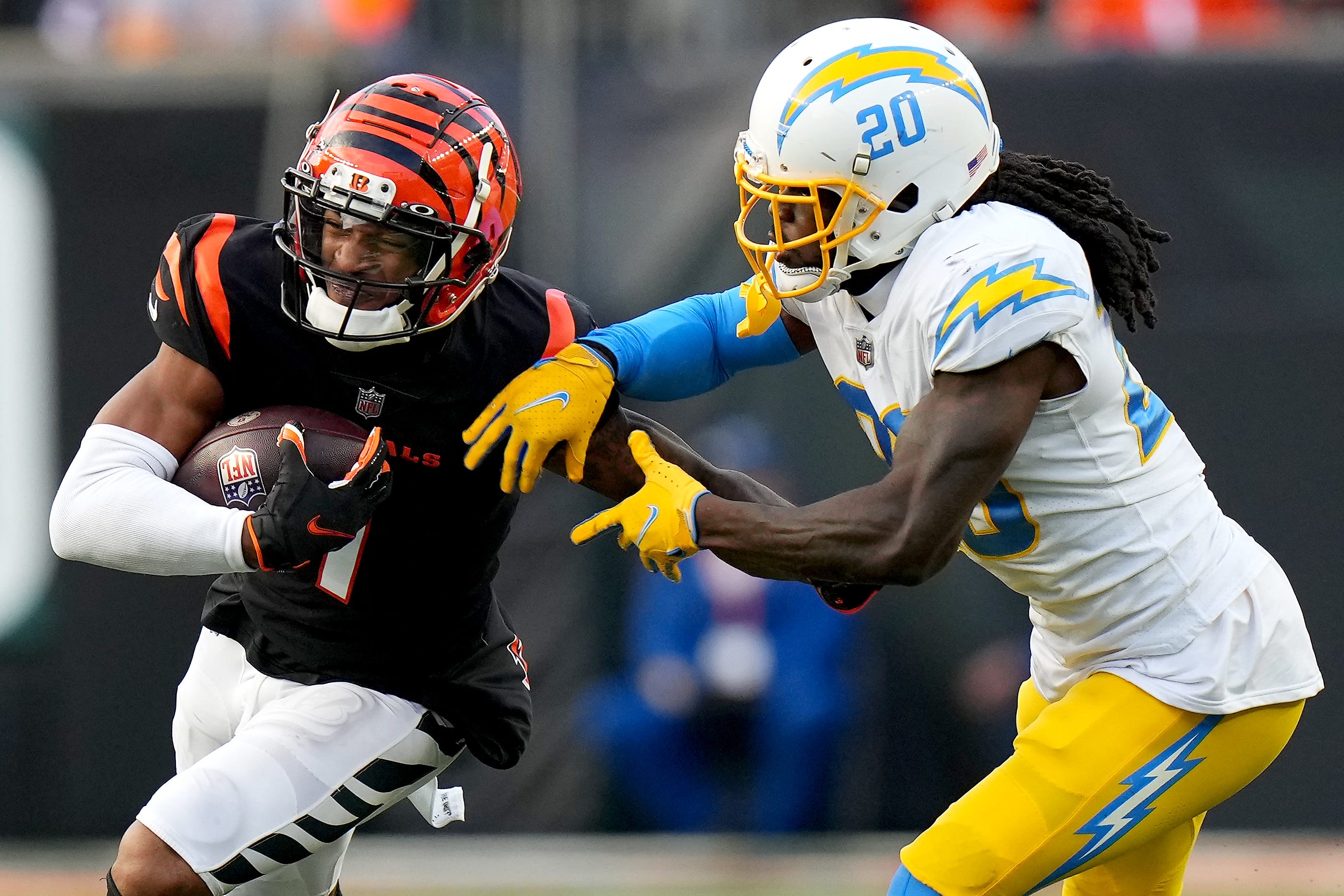 Cincinnati Bengals wide receiver Ja'Marr Chase (1) turns downfield after completing a catch as Los Angeles Chargers defensive back Tevaughn Campbell (20) defends in the fourth quarter during a Week 13 NFL football game, Sunday, Dec. 5, 2021, at Paul Brown Stadium in Cincinnati. The Los Angeles Chargers defeated the Cincinnati Bengals, 41-22. Los Angeles Chargers At Cincinnati Bengals Dec 5  