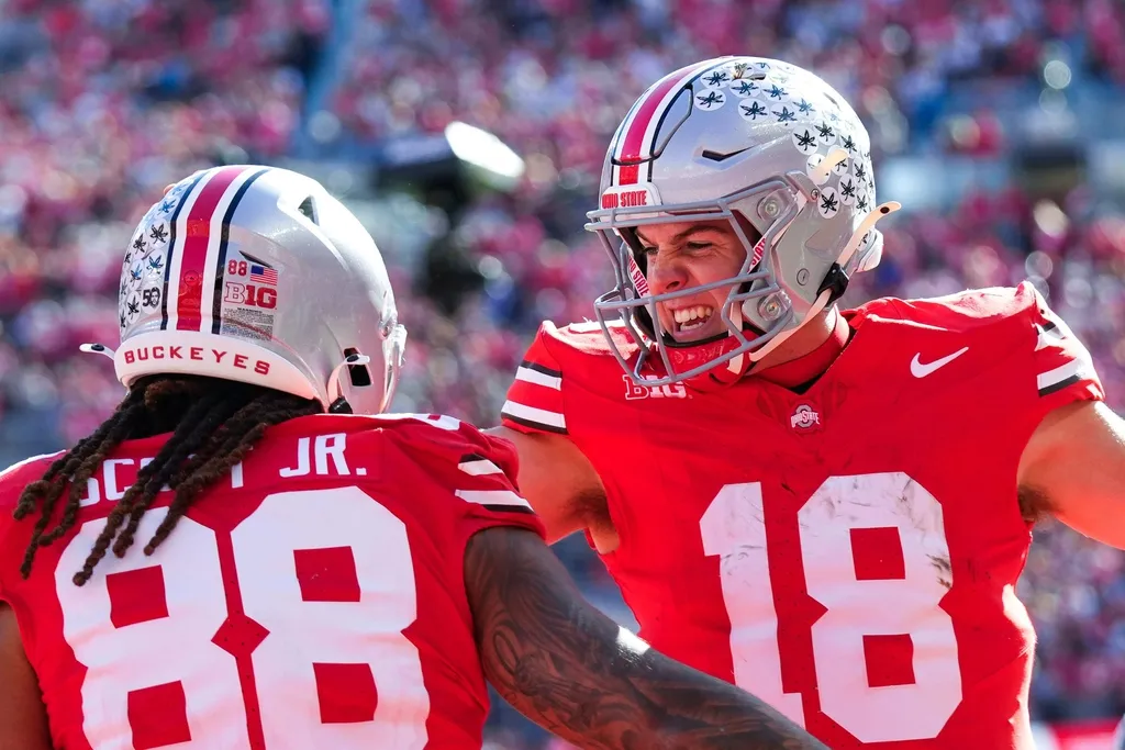 Ohio State Buckeyes quarterback Will Howard (18) celebrates with tight end Gee Scott Jr. (88) after Scott scored a touchdown in the first half at Ohio Stadium on Saturday, Nov. 9, 2024 in Columbus, Oh...