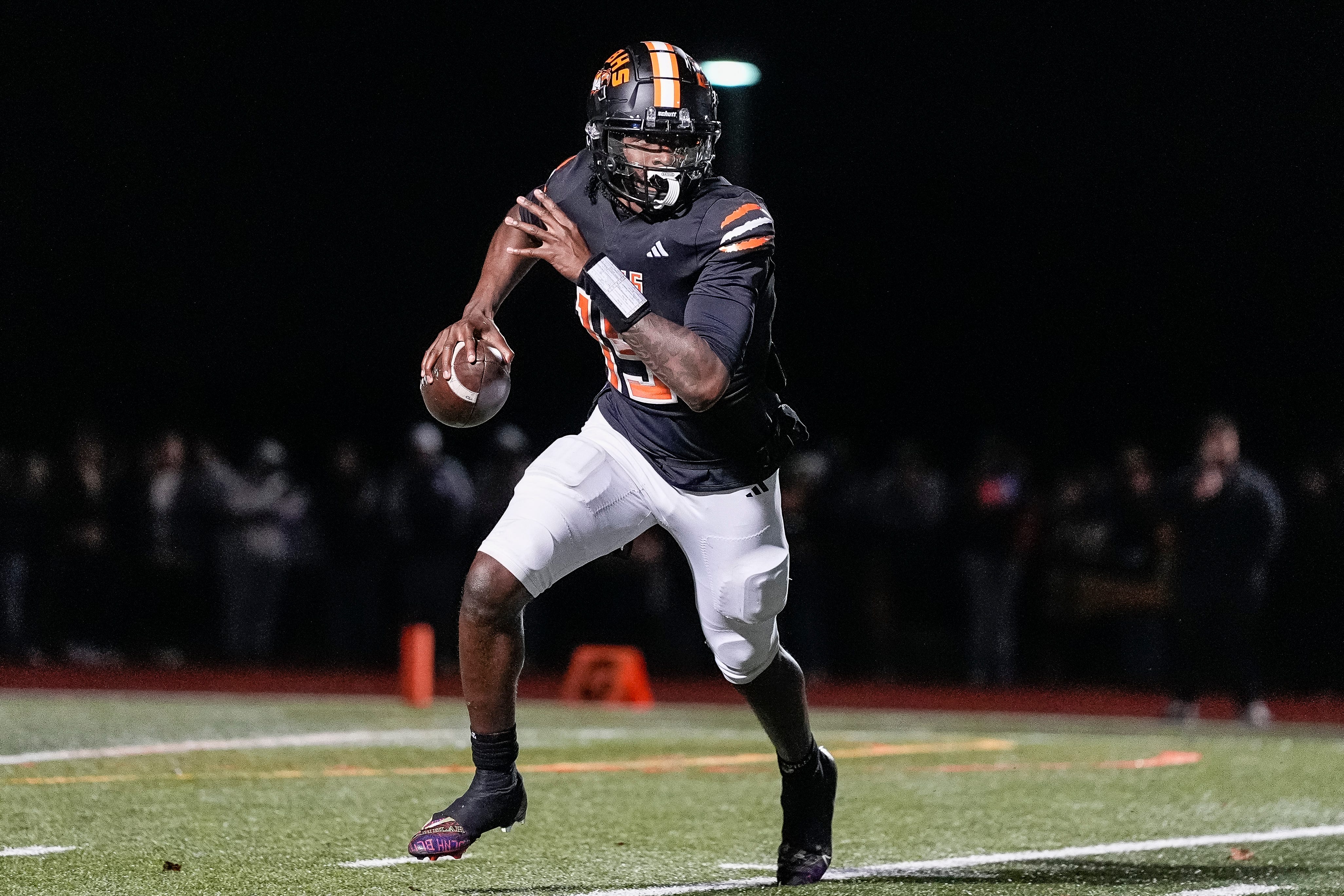 Belleville quarterback Bryce Underwood keeps the ball and runs against Saline during the second half of district final at Belleville High School in Belleville on Friday, Nov. 8, 2024.