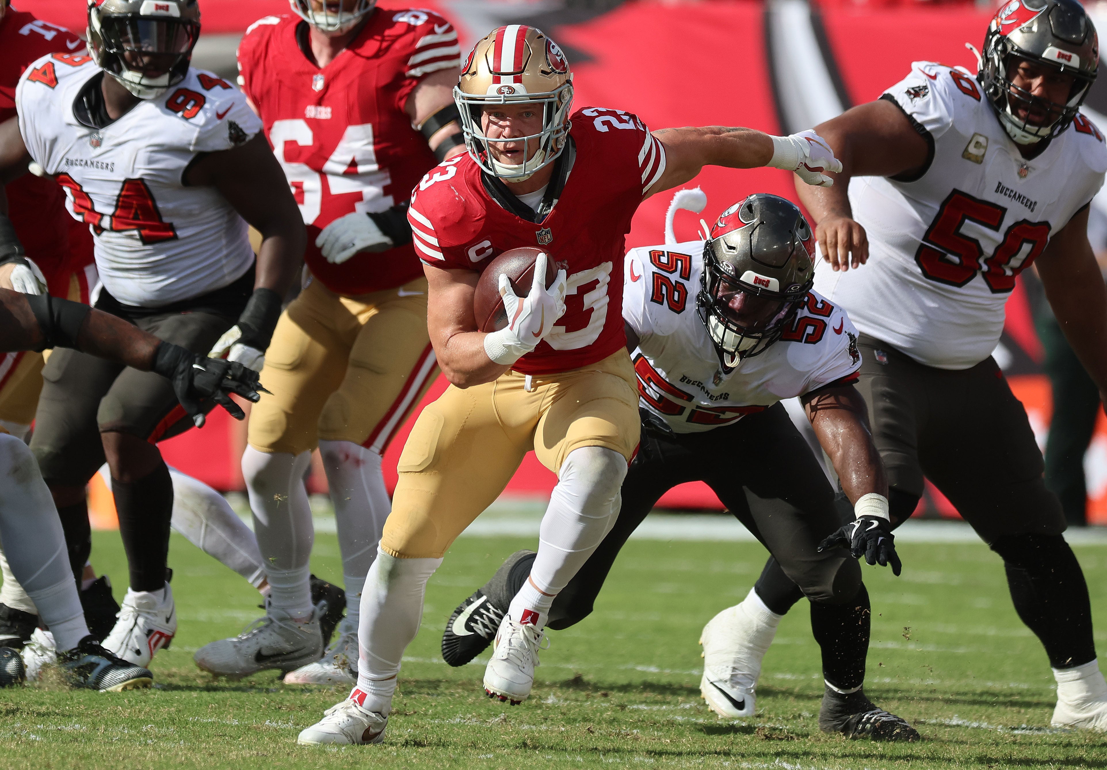 Nov 10, 2024; Tampa, Florida, USA; San Francisco 49ers running back Christian McCaffrey (23) runs with the ball against the Tampa Bay Buccaneers during the second half at Raymond James Stadium.