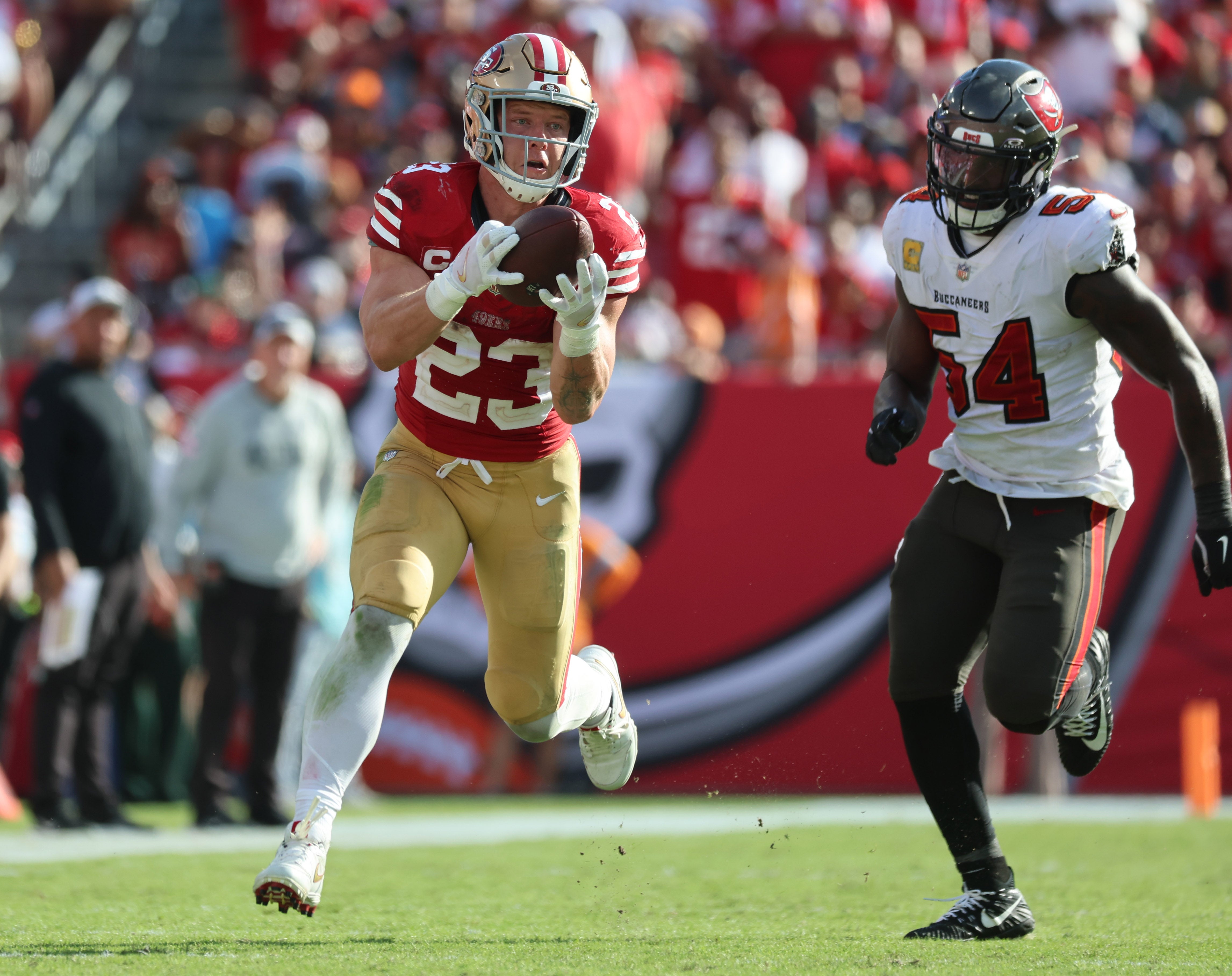 San Francisco 49ers running back Christian McCaffrey (23) catches the ball over Tampa Bay Buccaneers linebacker Lavonte David (54) during the second half at Raymond James Stadium.