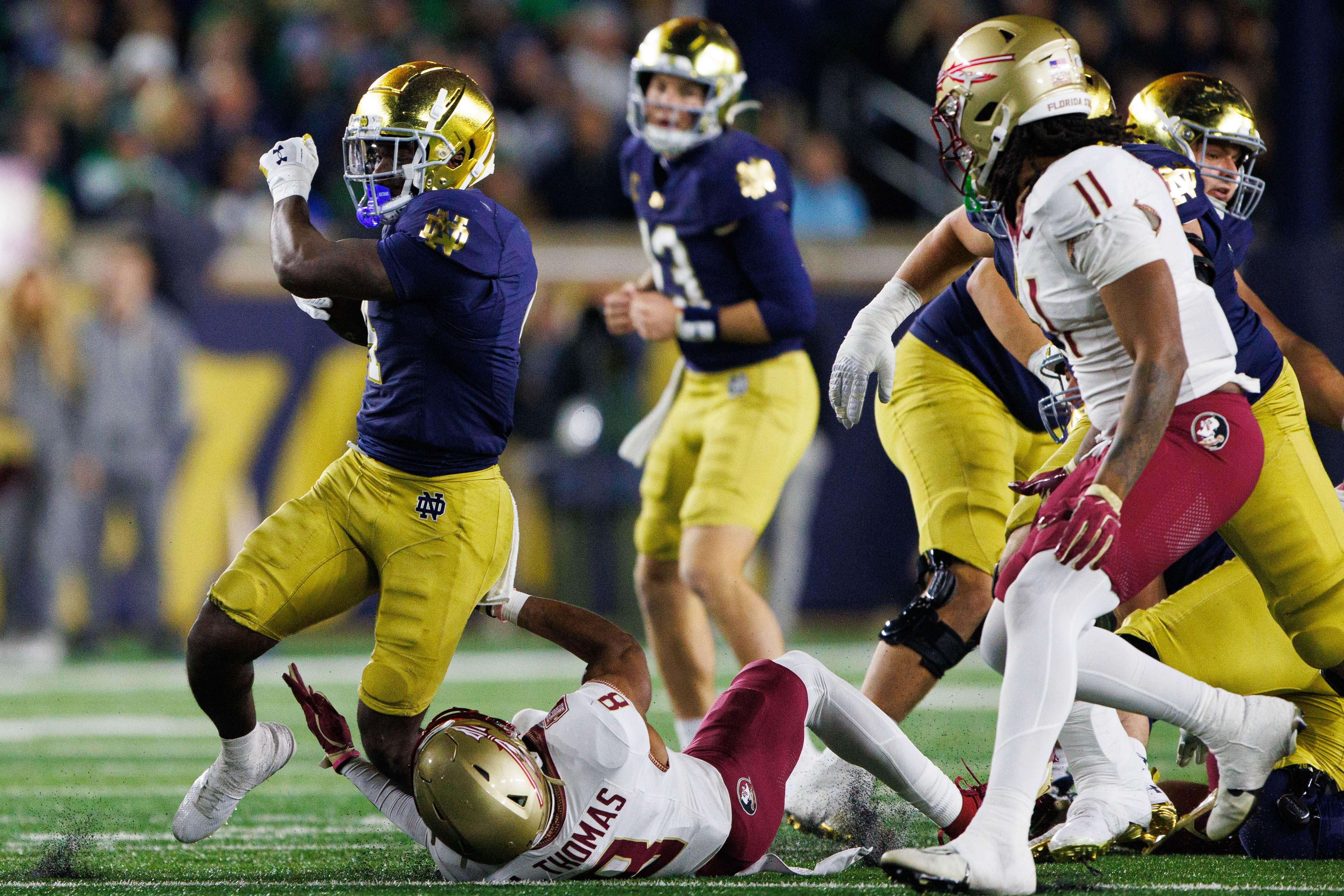 Florida State defensive back Azareye'h Thomas (8) tackles Notre Dame running back Jeremiyah Love (4) during a NCAA college football game at Notre Dame Stadium on Saturday, Nov. 9, 2024, in South Bend.