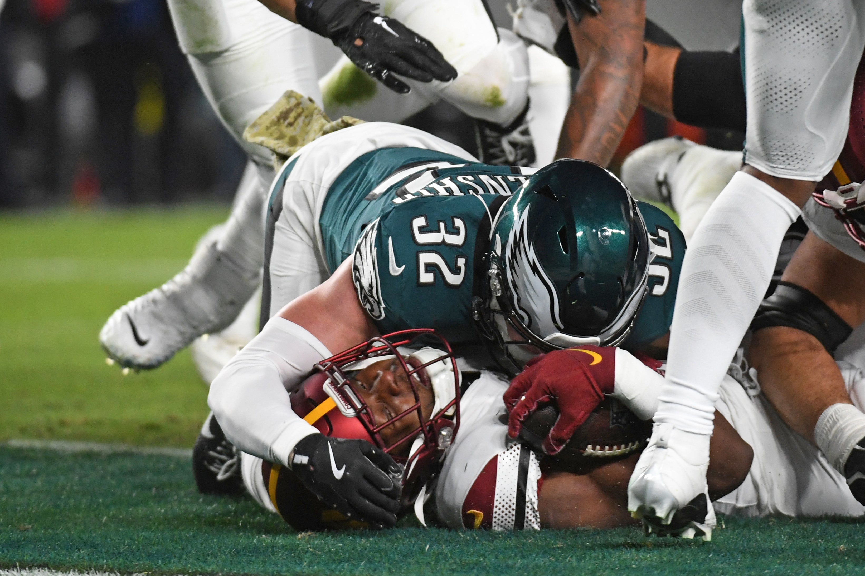 Nov 14, 2024; Philadelphia, Pennsylvania, USA; Washington Commanders running back Brian Robinson Jr. (8) scores a d against Philadelphia Eagles safety Reed Blankenship (32) during the first quarter at Lincoln Financial Field.