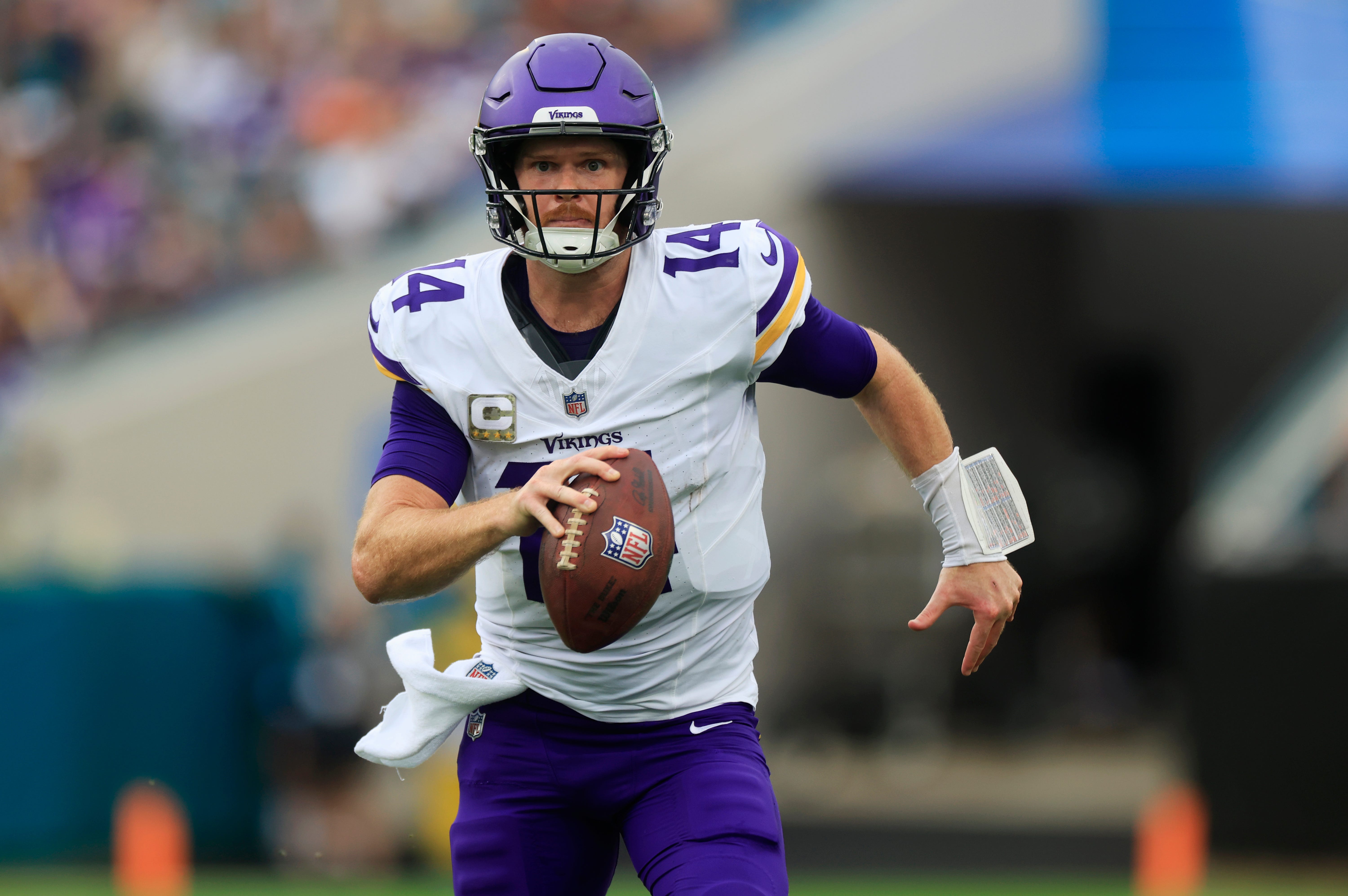 Minnesota Vikings quarterback Sam Darnold (14) is pressured out of the pocket and forced to run during the second quarter an NFL football matchup Sunday, Nov. 10, 2024 at Everbank Stadium in Jacksonville, Fla. The Vikings defeated the Jaguars 12-7.